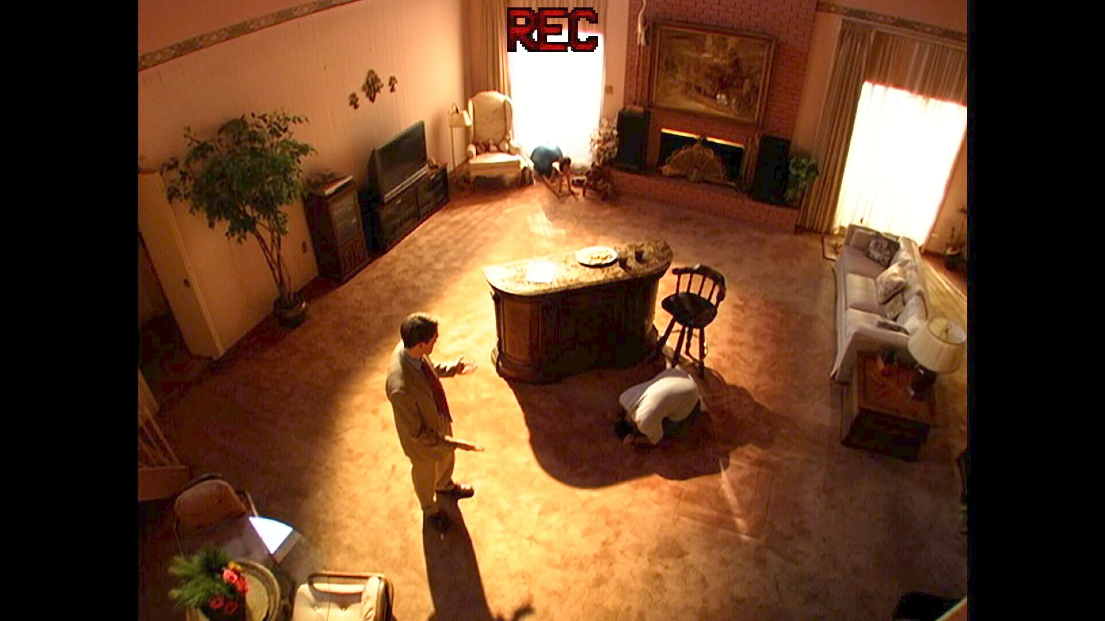 A high-angle recording shows Hansen and another man beside a kitchen counter.