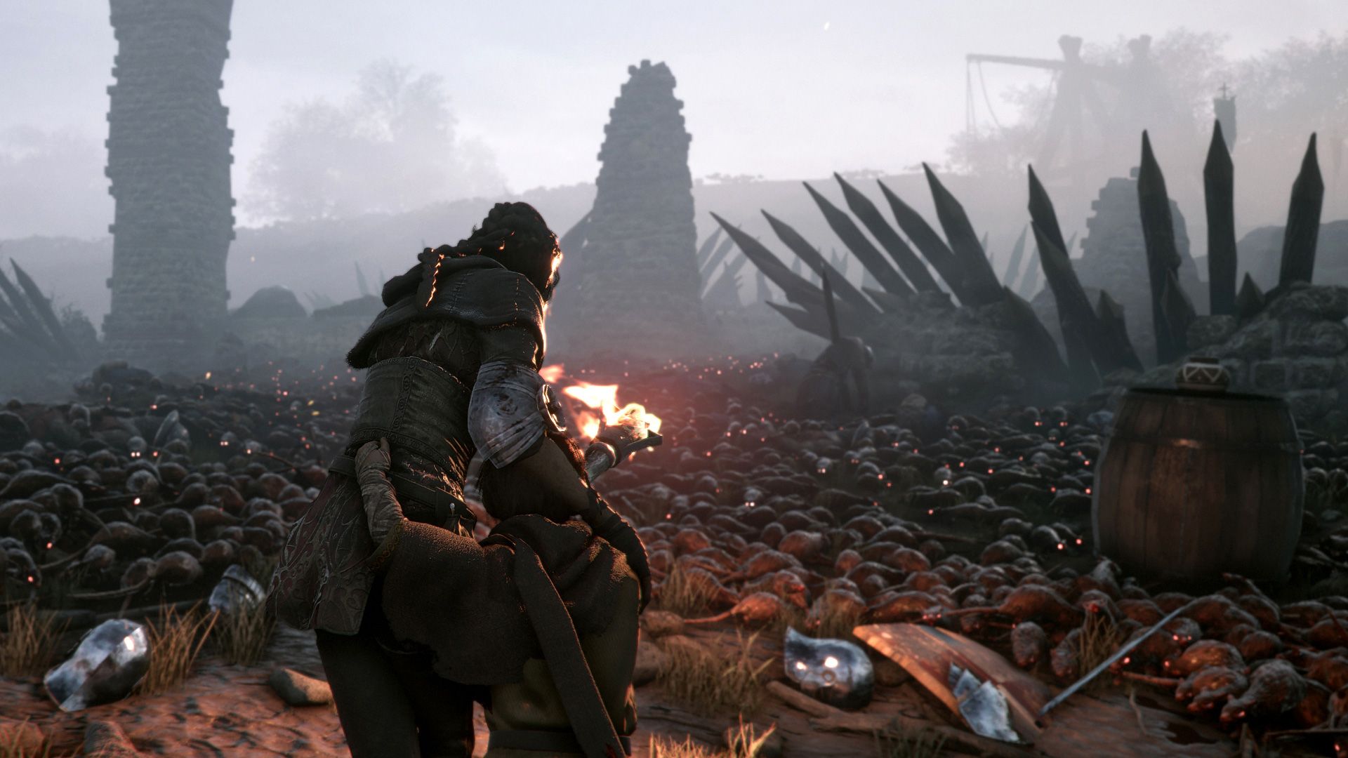 Amicia holds a burning light near a large swarm of rats.