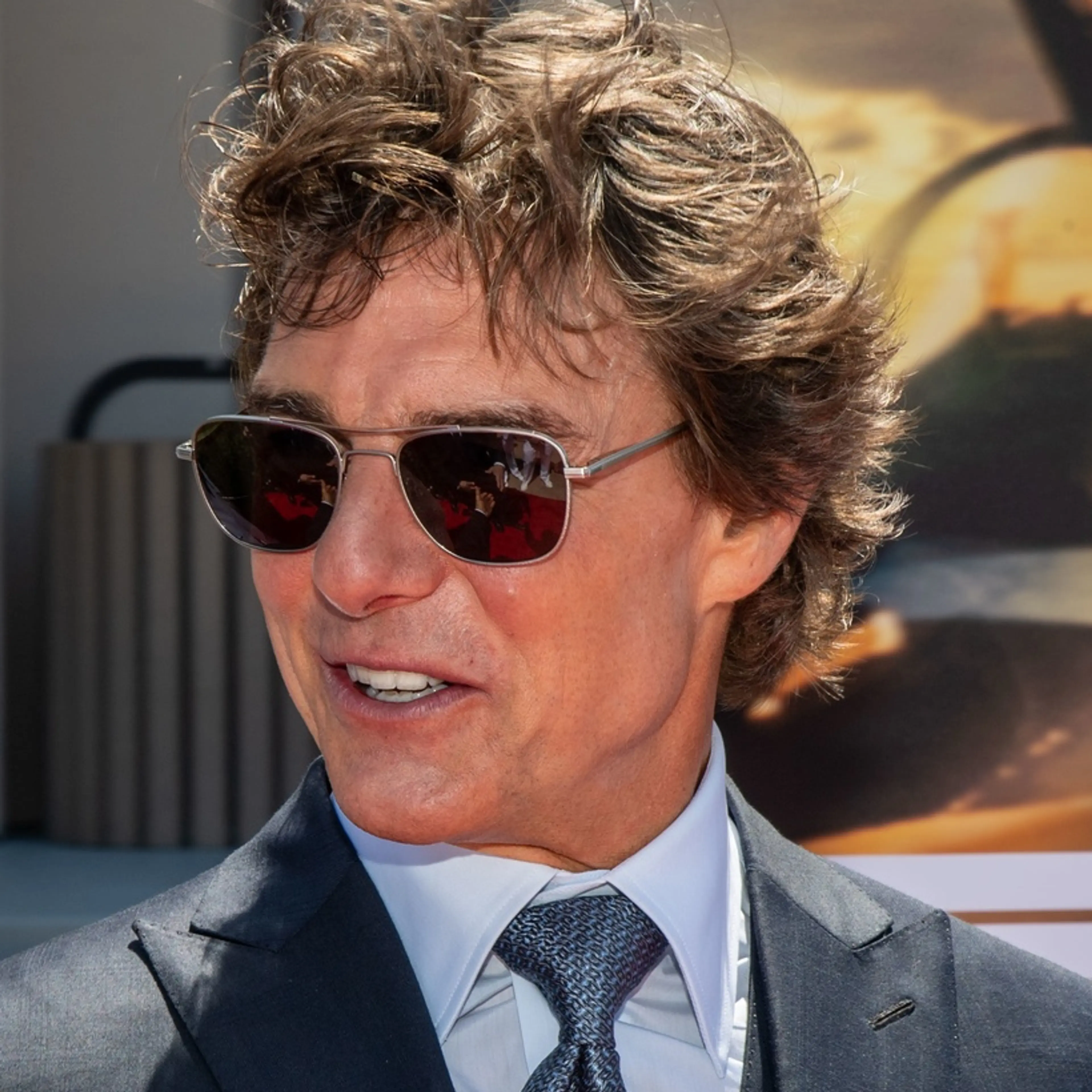 Tom Cruise in sunglasses and a dark suit at the 2022 Top Gun: Maverick premiere.