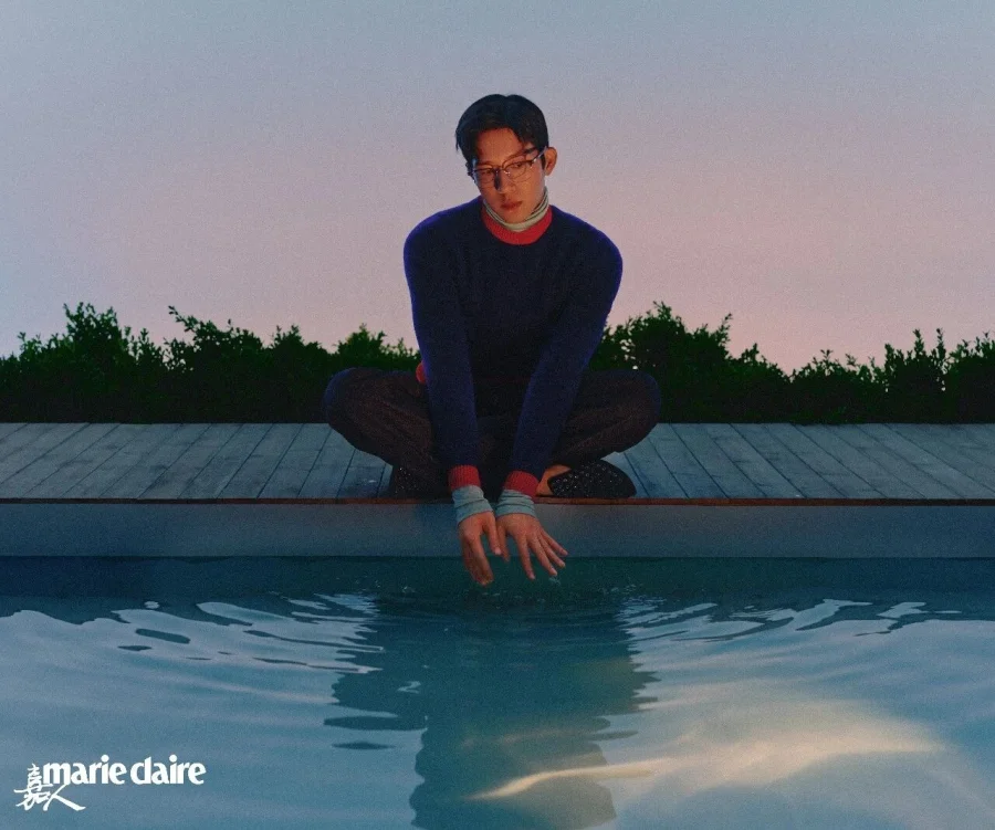 Jing Boran seated beside a pool in the Marie Claire China photo story.