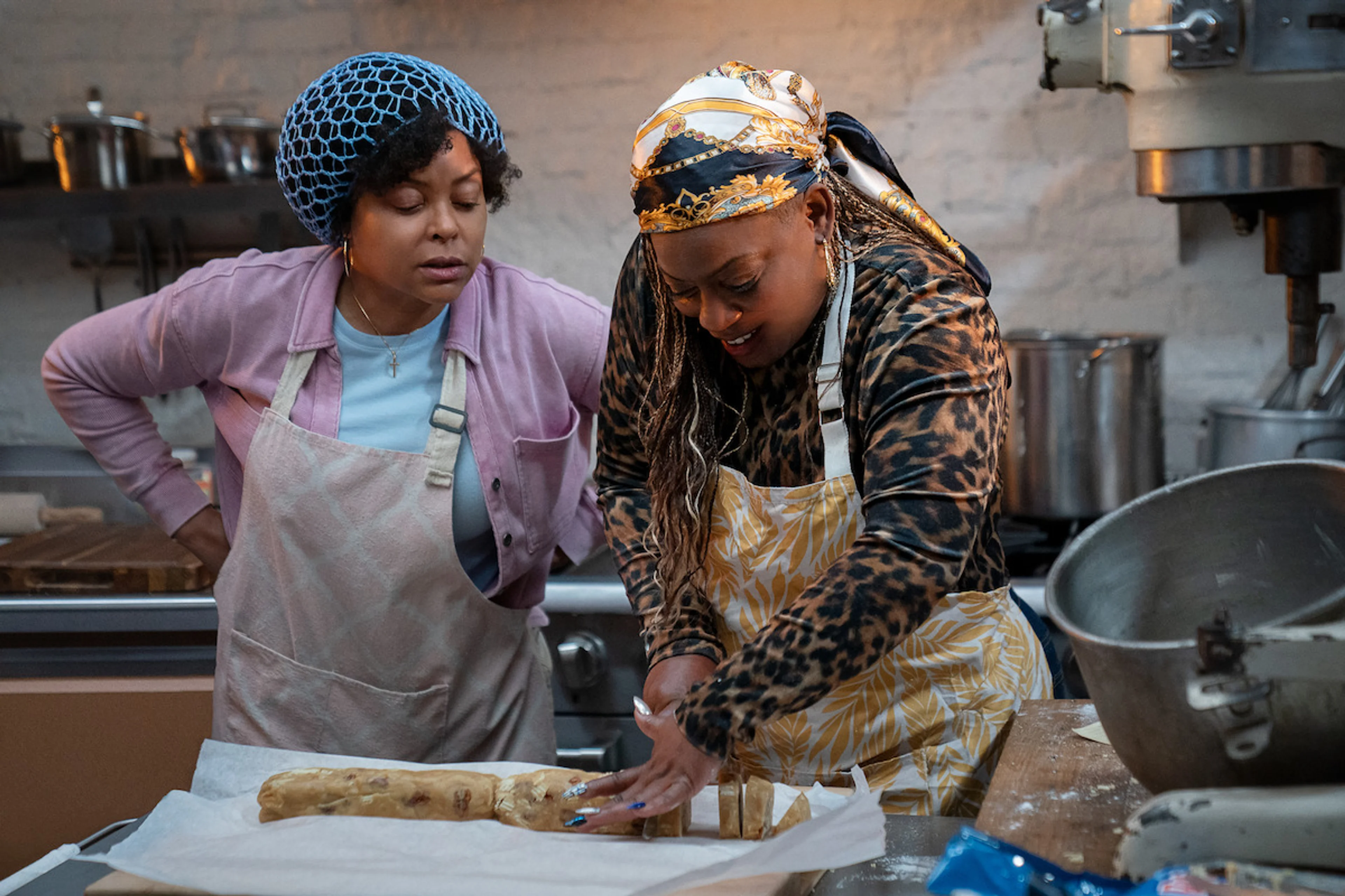 Two women prepare dough together in a bakery kitchen in Give Me Some Sugah.