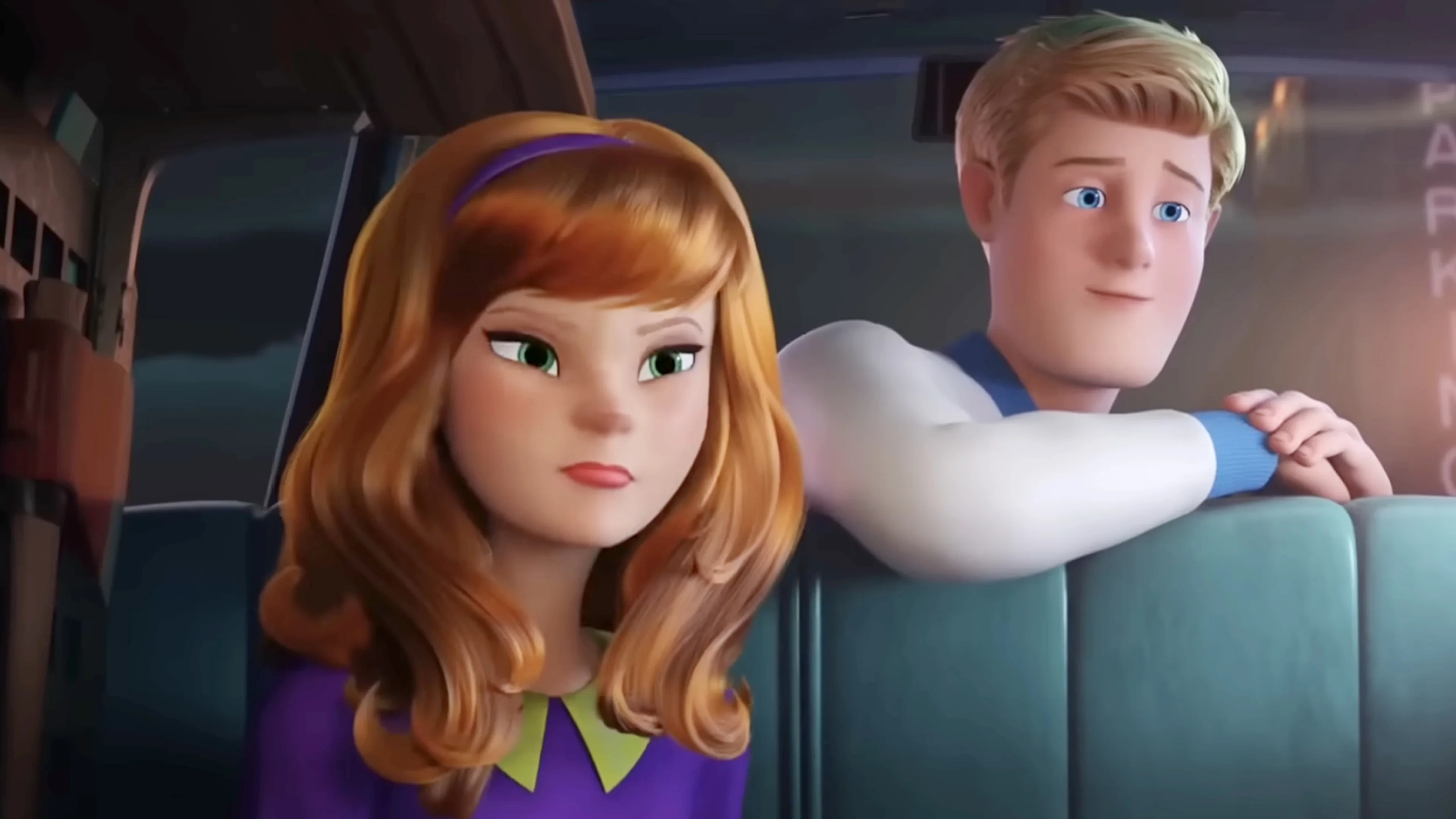 Young Daphne sits beside young Fred in the animated movie Scoob!