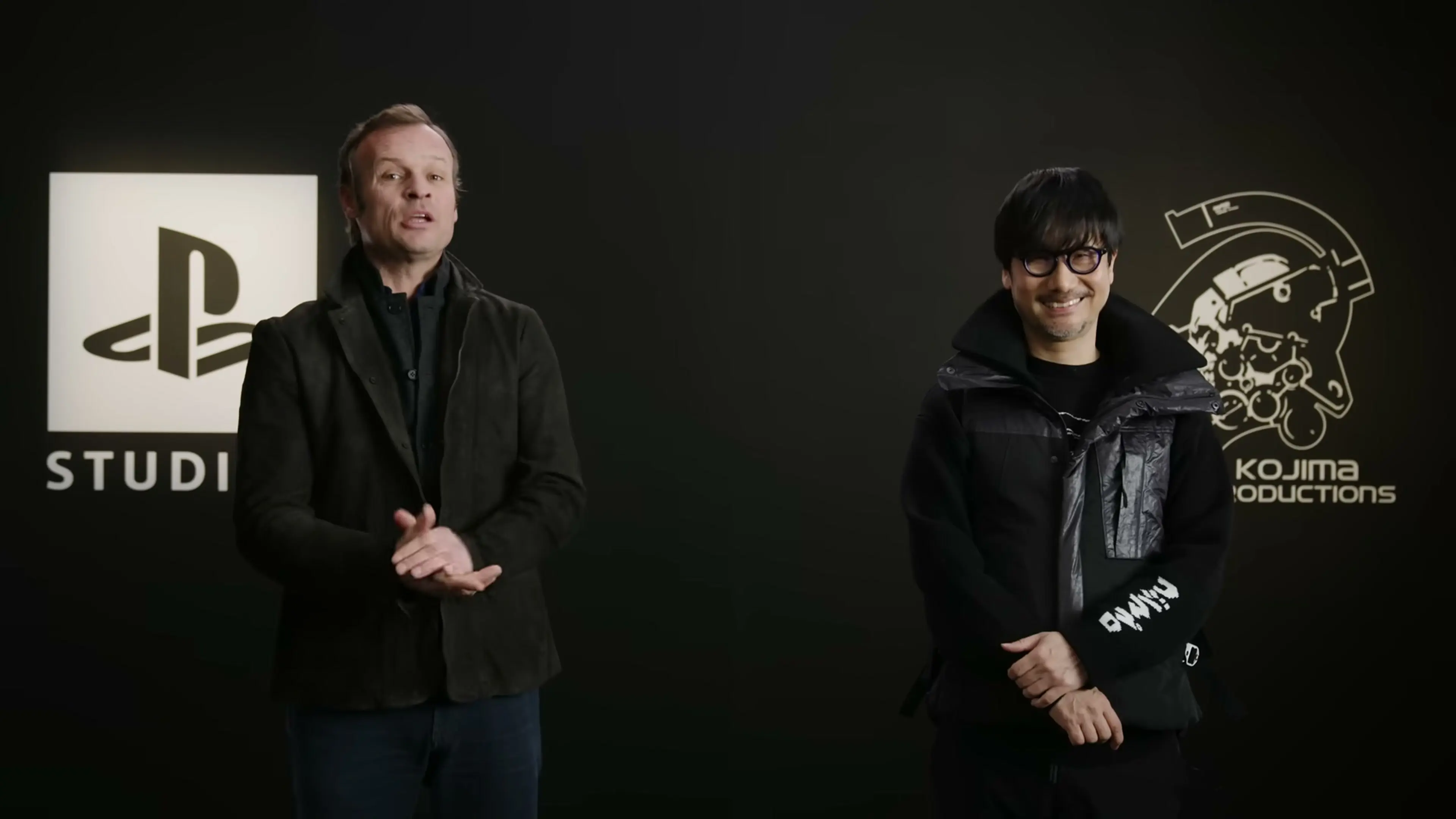Hermen Hulst and Hideo Kojima stand between PlayStation Studios and Kojima Productions logos.