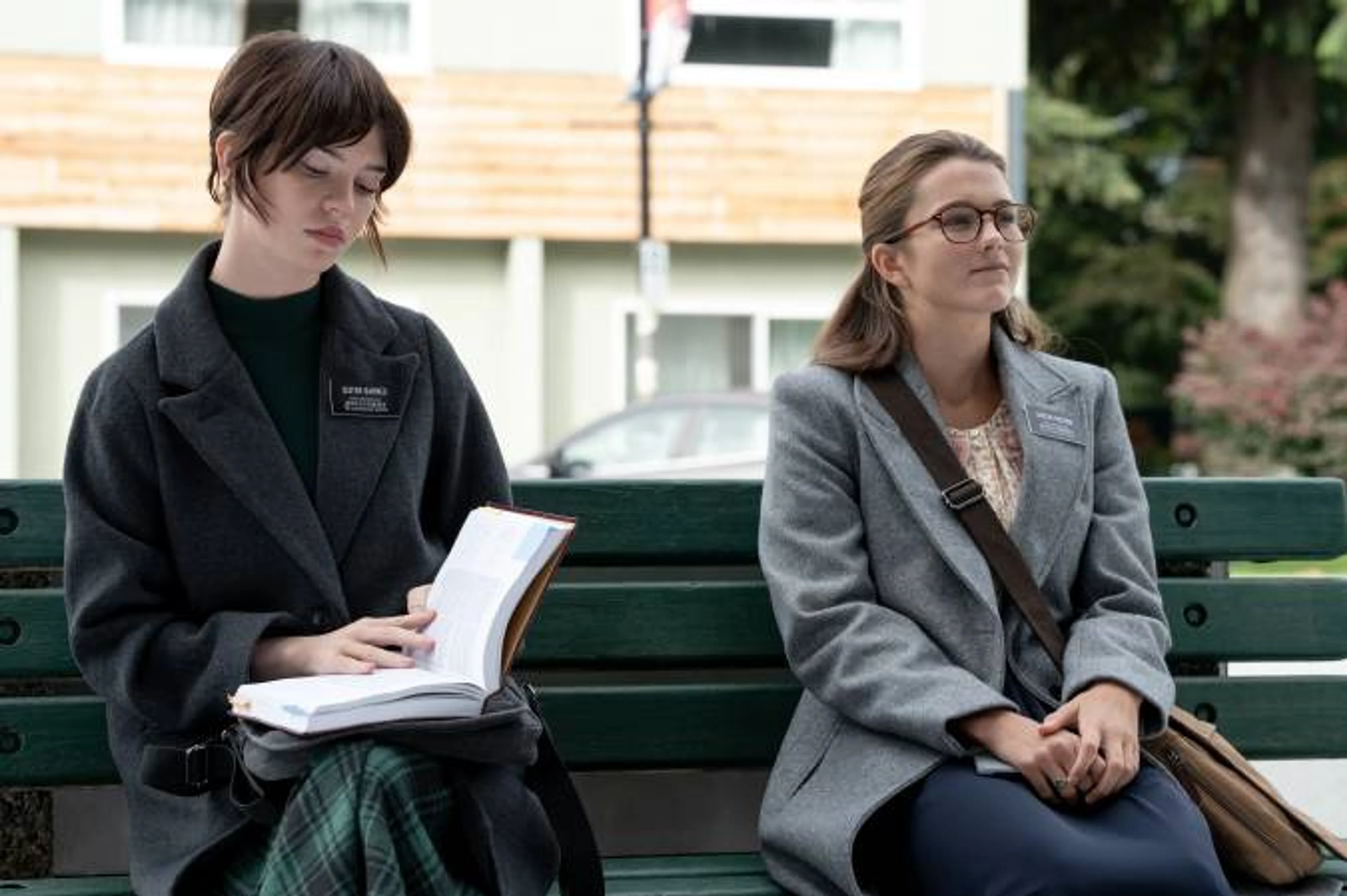 Sister Barnes and Sister Paxton sit side by side, with a book open on Barnes’ lap.
