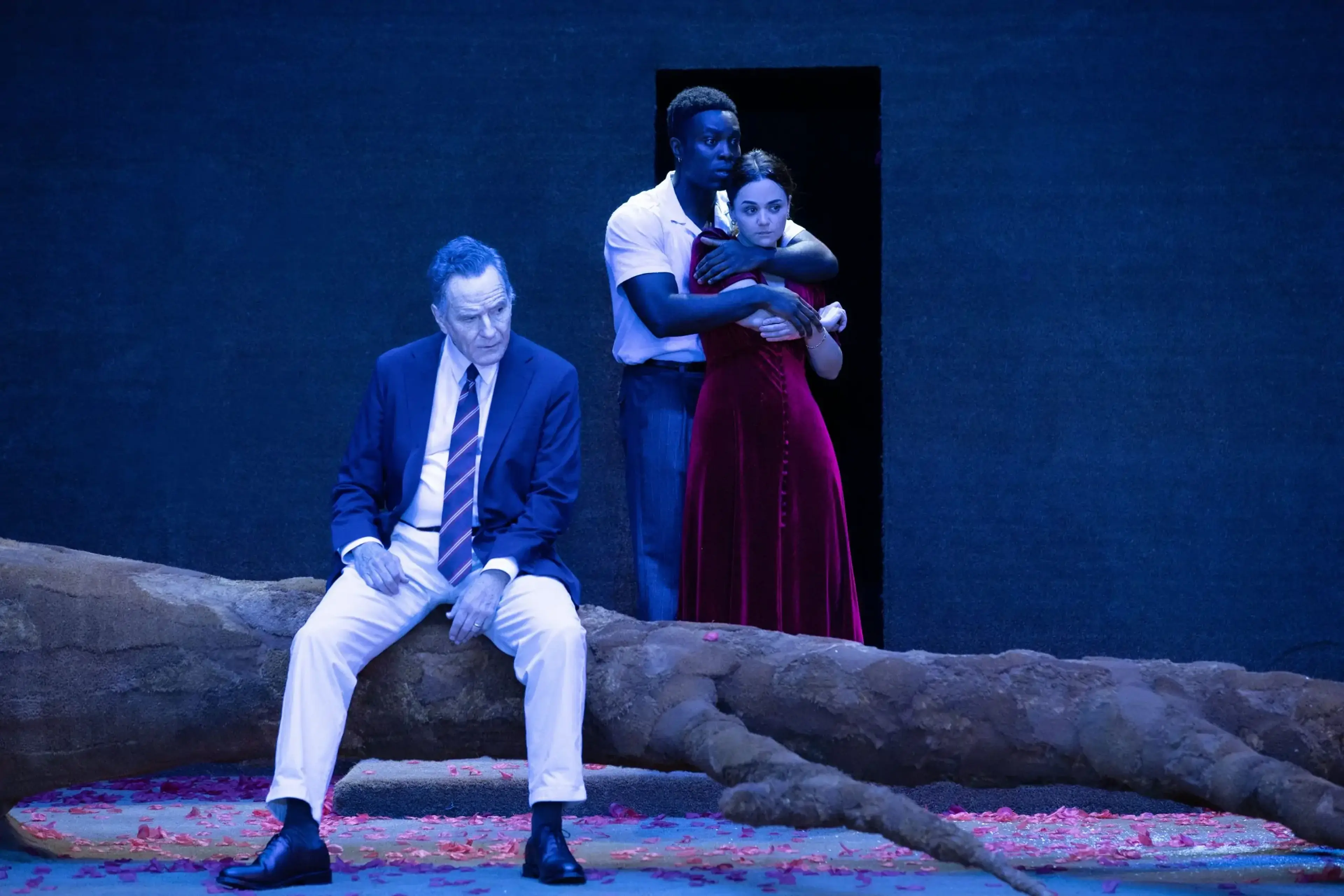 Bryan Cranston sits in the foreground while Paapa Essiedu stands behind Hayley Squires in All My Sons.
