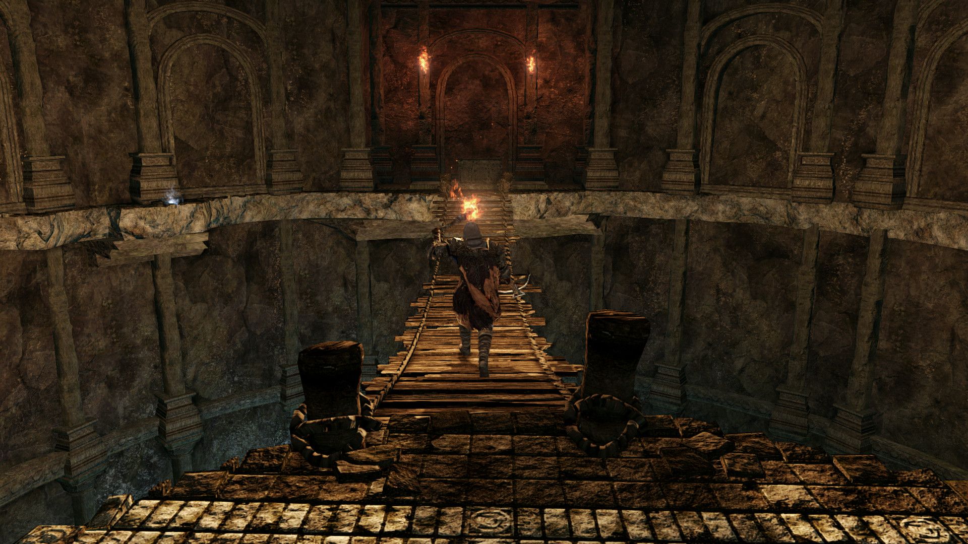 A narrow bridge crosses a threatening part of Drangleic.