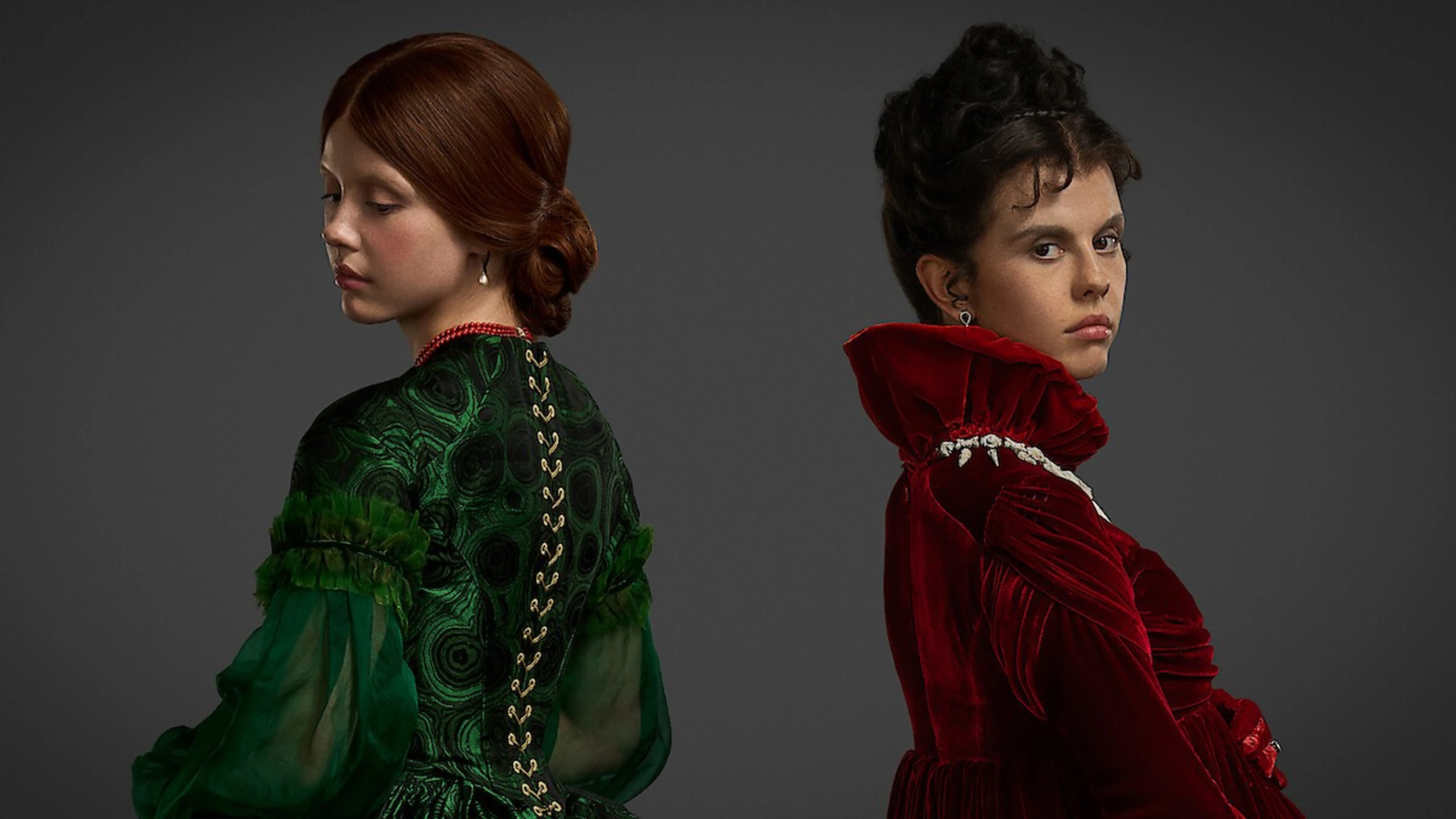 Mia Goth appears in red and green costumes as two characters from Frankenstein.
