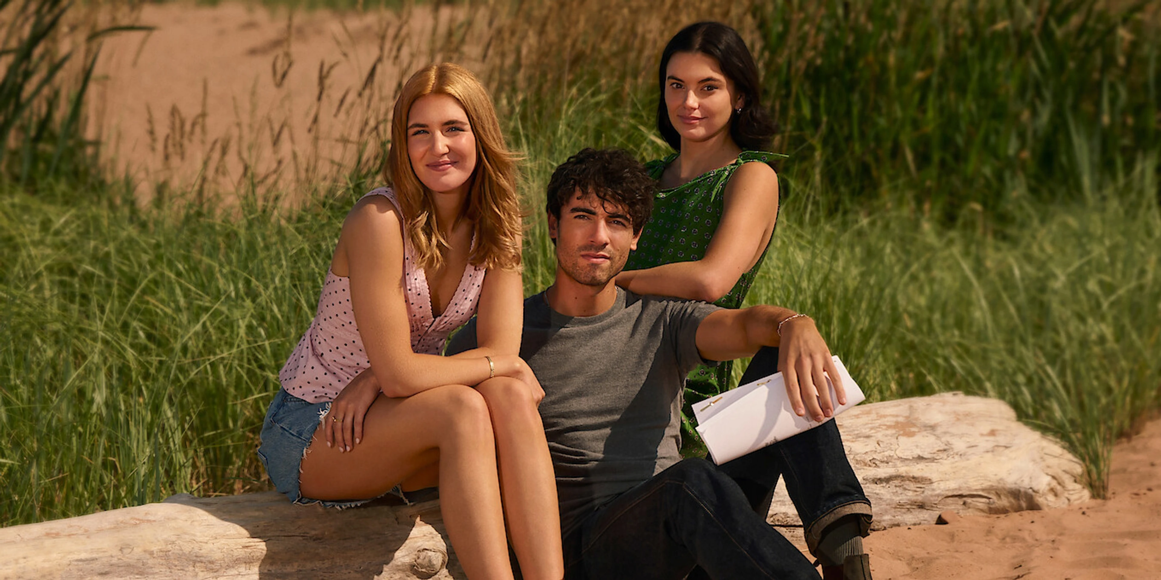 Sophie Nélisse, Roby Attal and Francesca Reale seated together on a beach for This Summer Will Be Different.