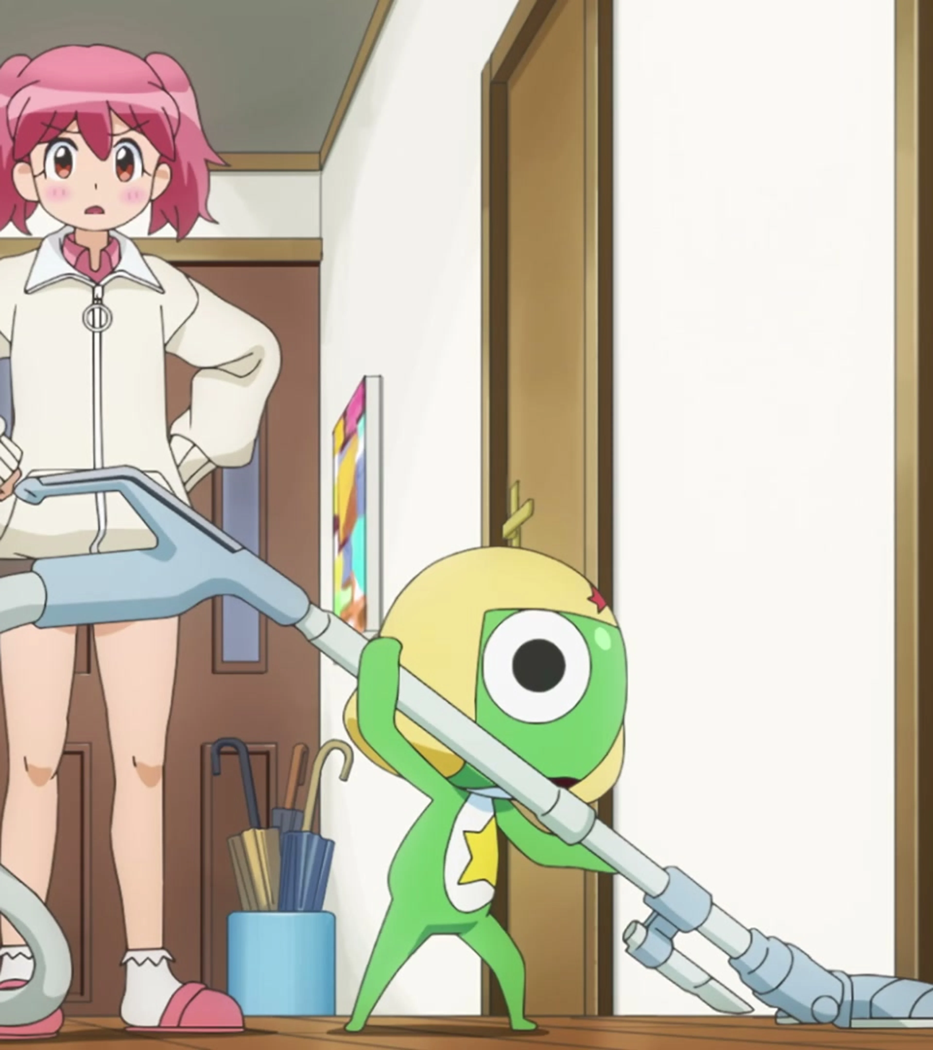 Keroro confidently vacuums the Hinata home while Natsumi watches from the hallway in the new Sgt. Frog anime trailer.