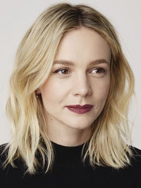 Portrait of Carey Mulligan with shoulder-length blonde hair and a black top.