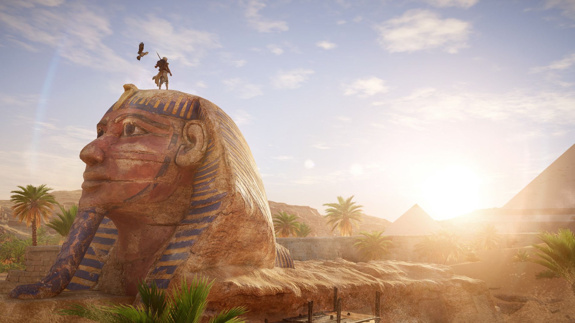 An eagle flies above a stone sphinx in Egypt.