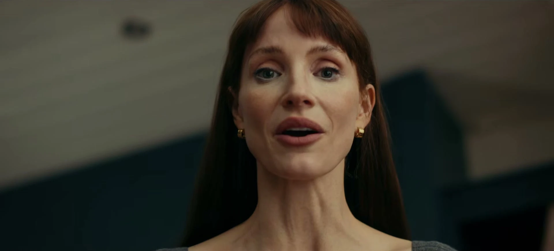 Jessica Chastain looks down with a controlled expression in Other Mommy.