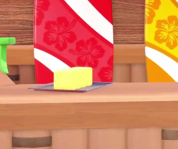Butter pickup on the Surfboard Shop counter beside striped surfboards.