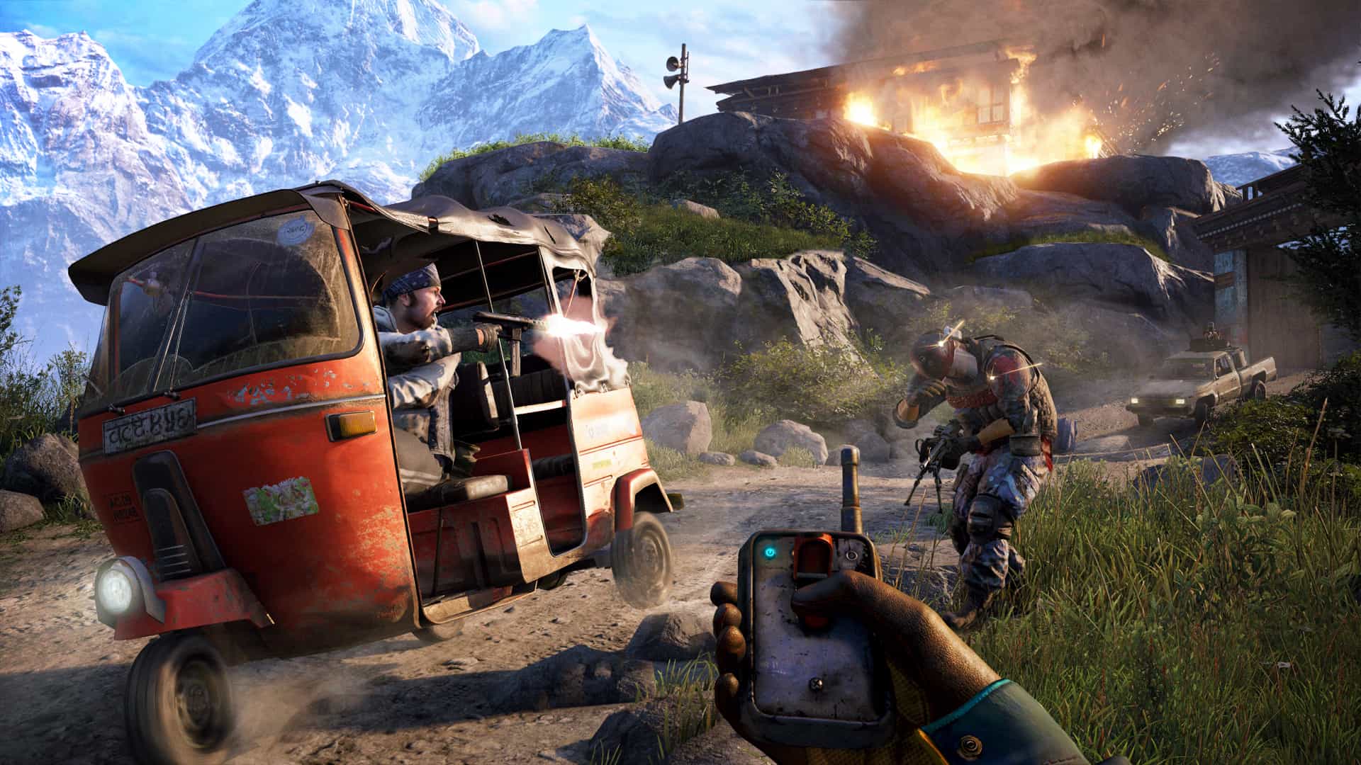 Ajay holds a detonator while an auto-rickshaw and fighters fill the road ahead.