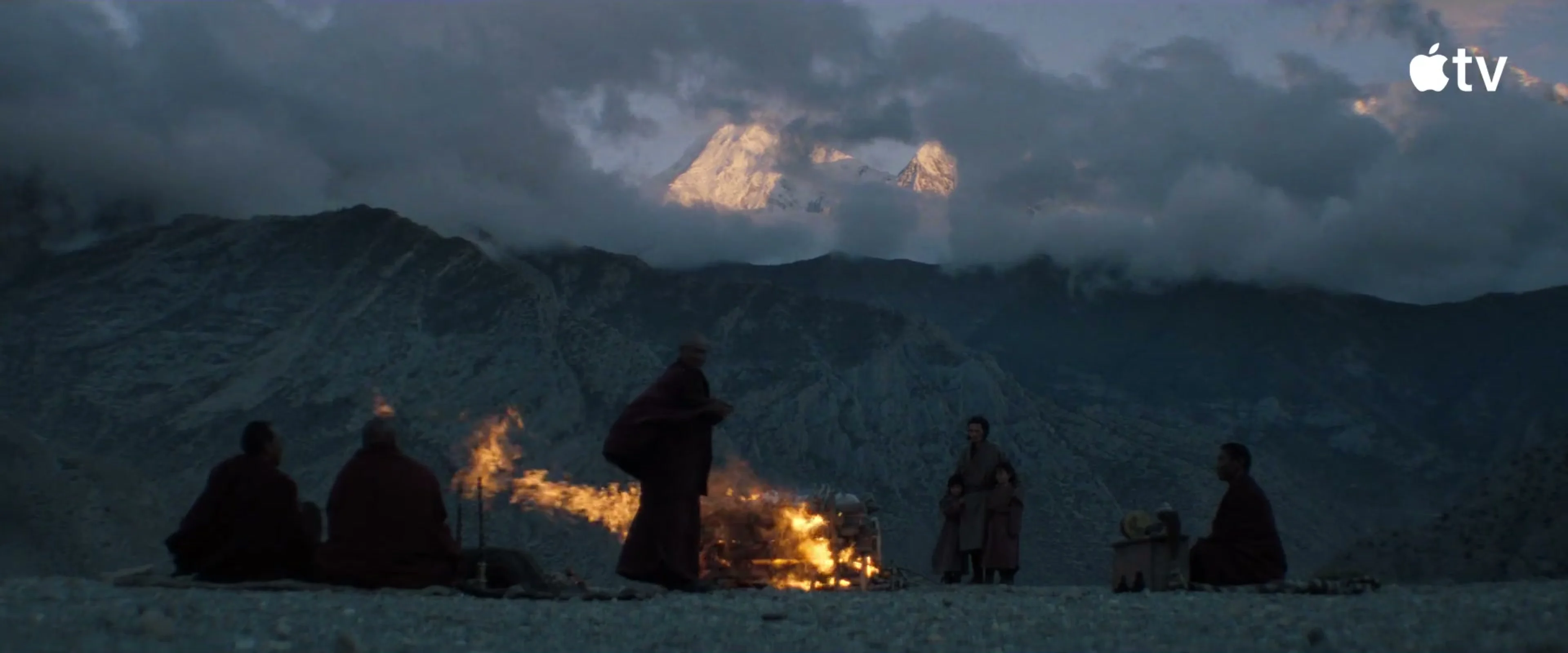 A mountain ceremony takes place at dusk in Tenzing.