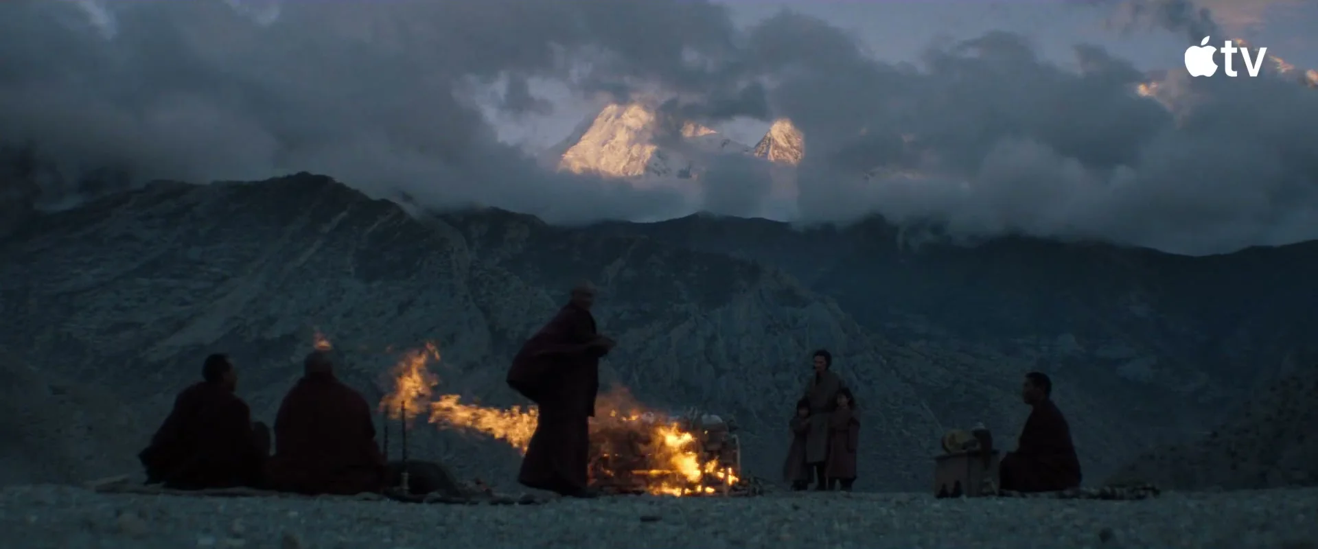 A mountain ceremony takes place at dusk in Tenzing.