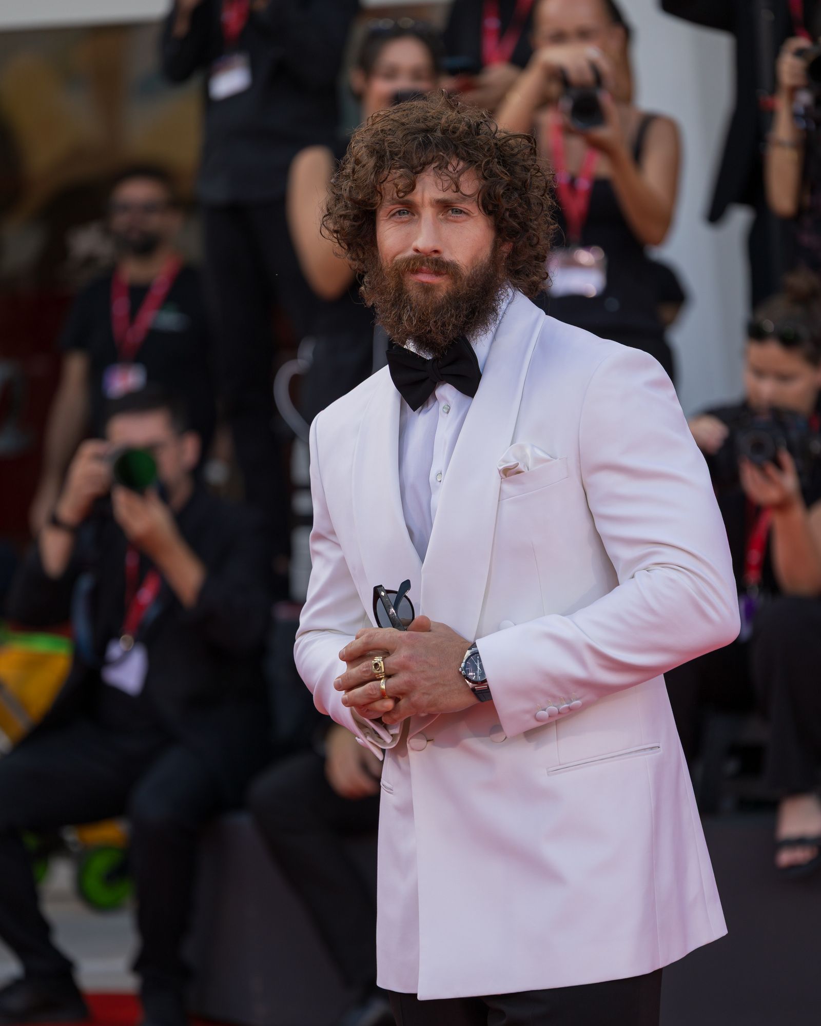 Aaron Taylor-Johnson wears a pale suit on the Venice Film Festival red carpet.