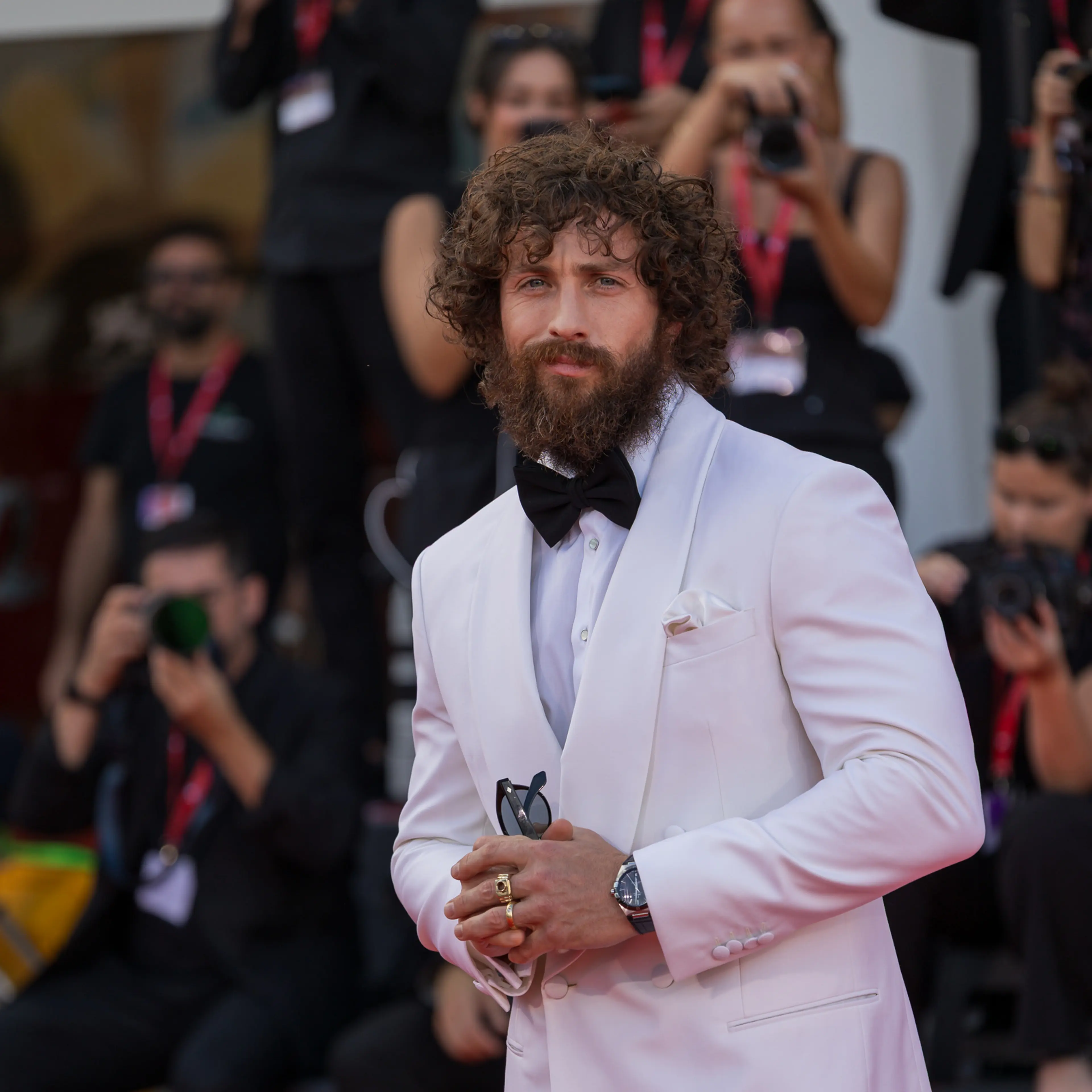 Aaron Taylor-Johnson wears a pale suit on the Venice Film Festival red carpet.
