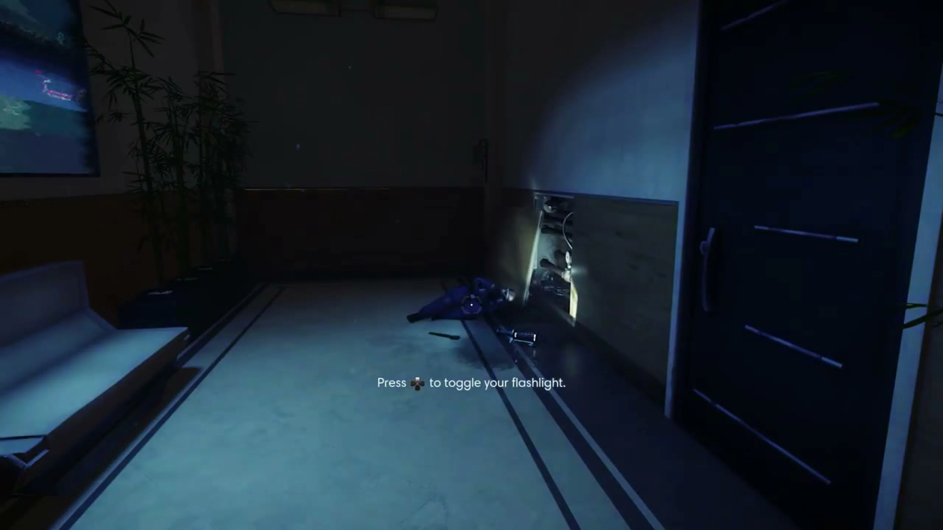 Dark hallway outside Morgan’s apartment, with a body on the floor by the right wall.