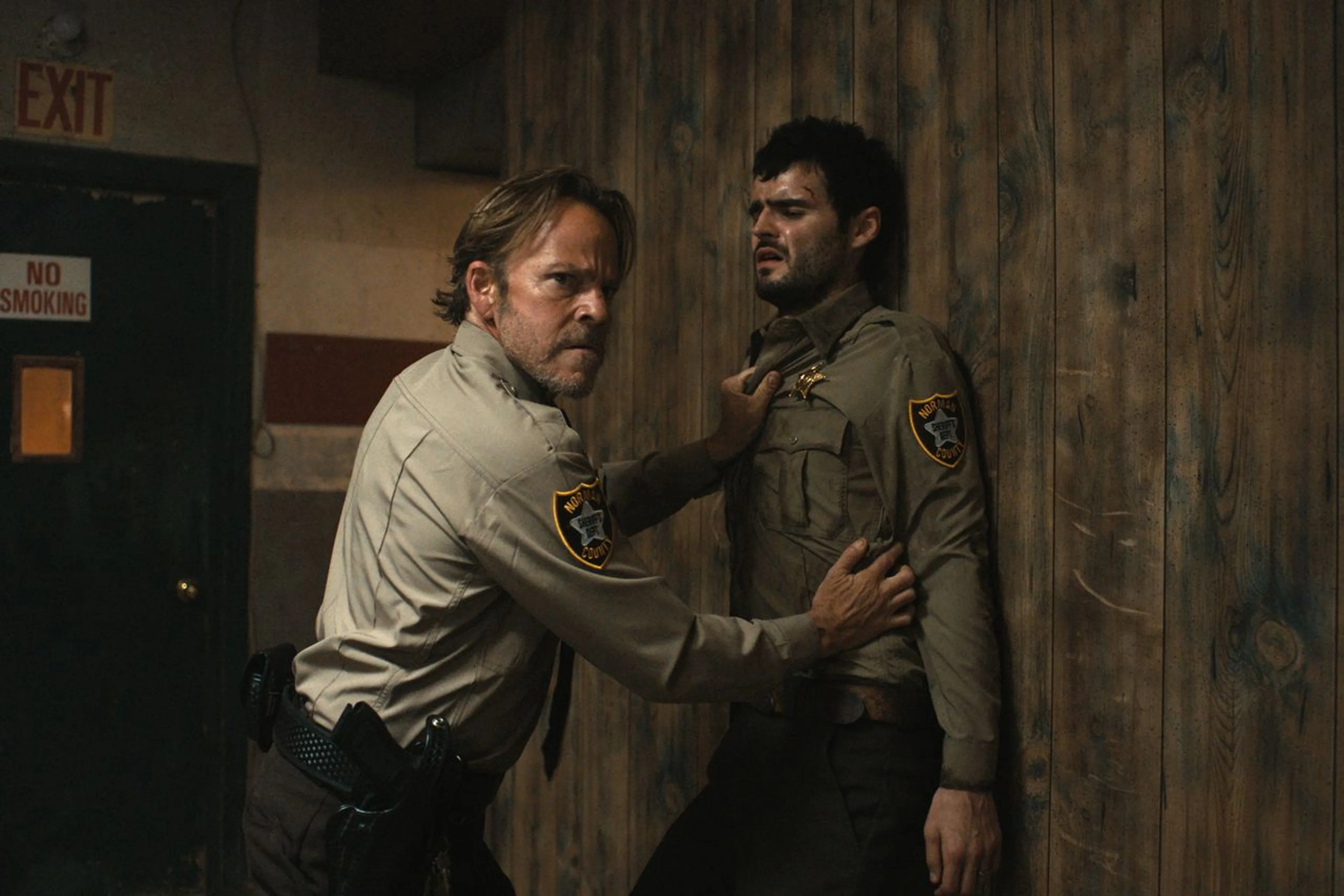 Stephen Dorff confronts Duke Nicholson in a wood-paneled room in The Deputy.