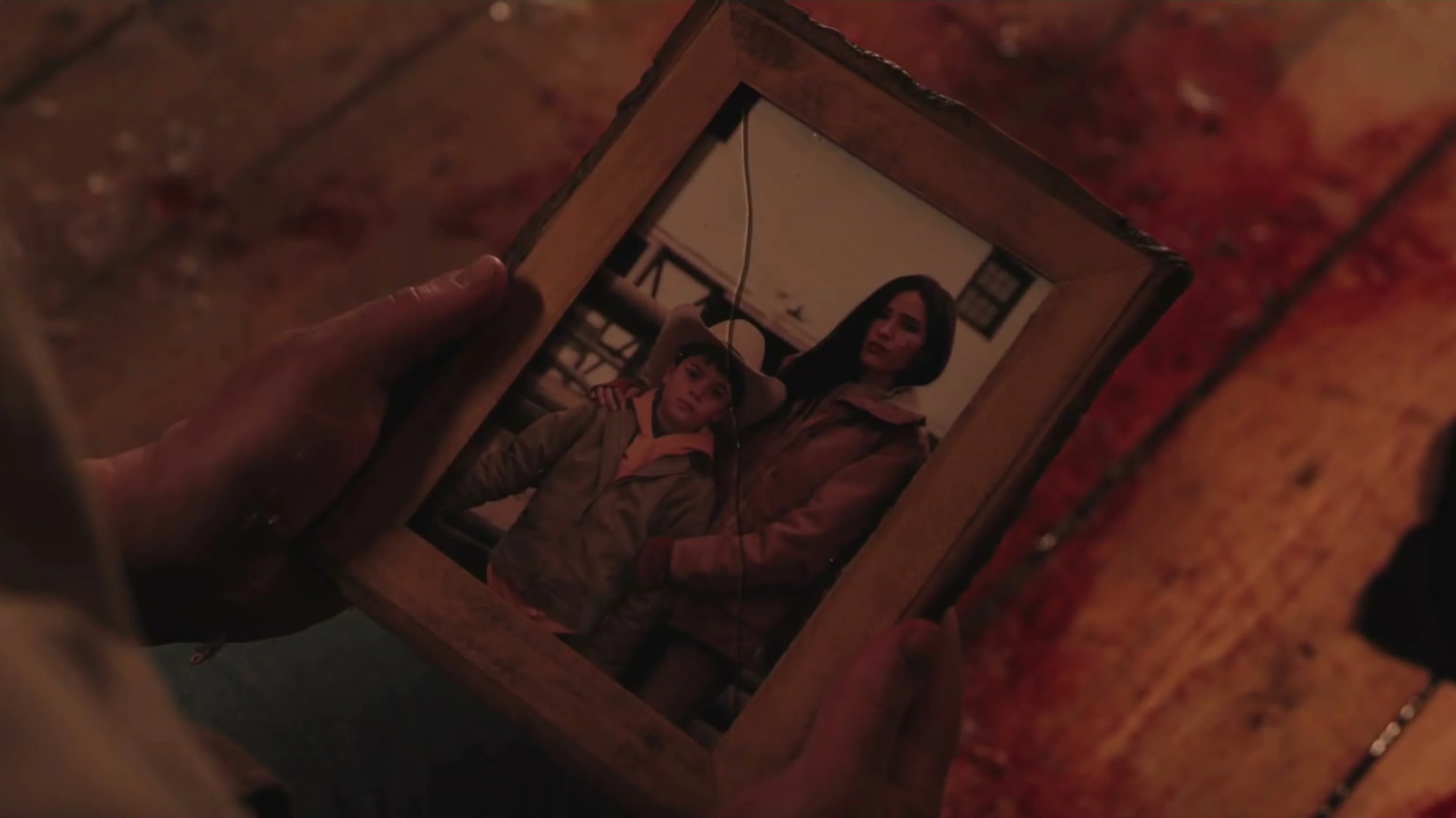 A hand holds an old family photograph in Marshals Season 2.
