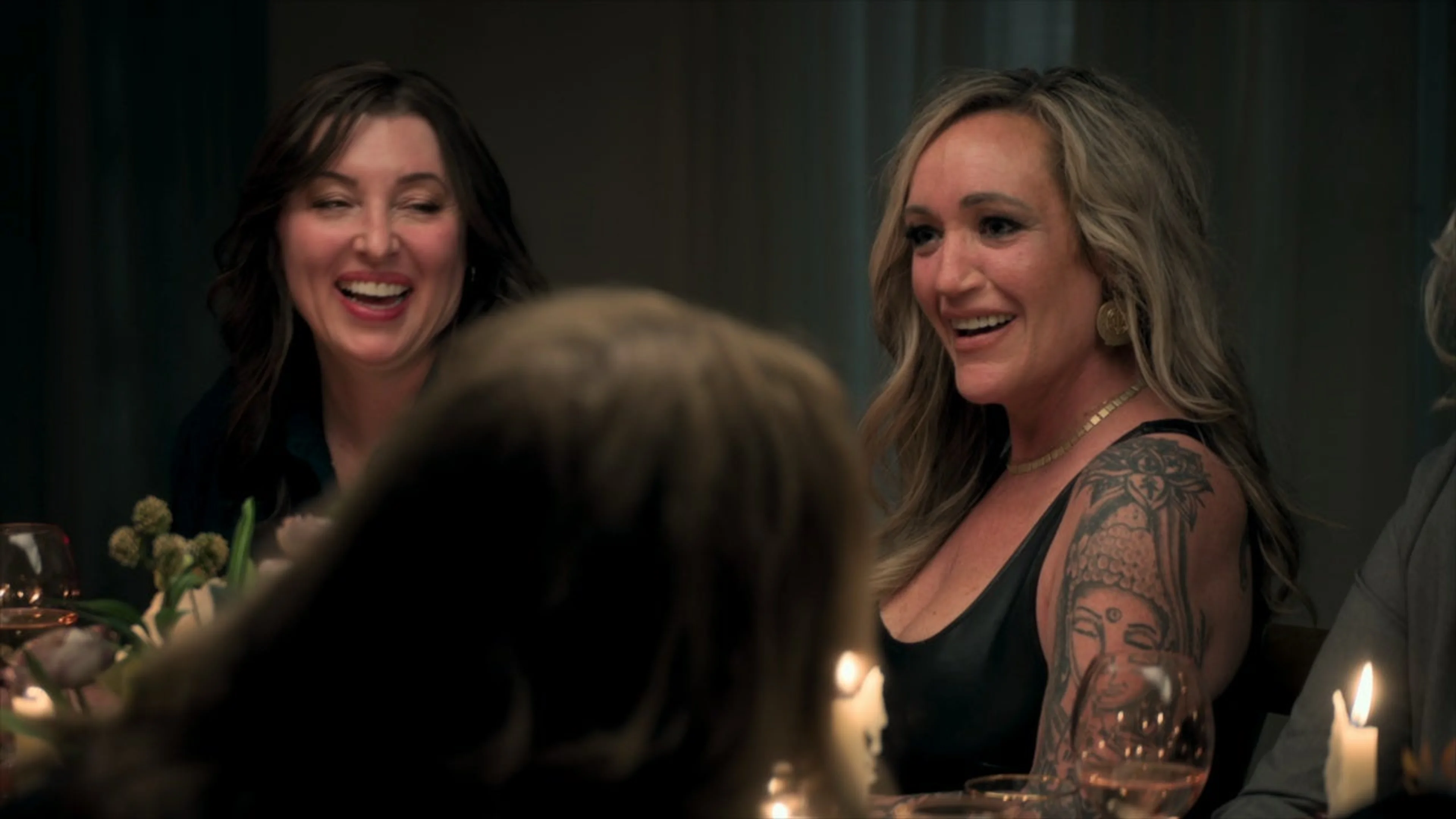Former contestants smile together around a table in The Swan: Behind the Mirror.