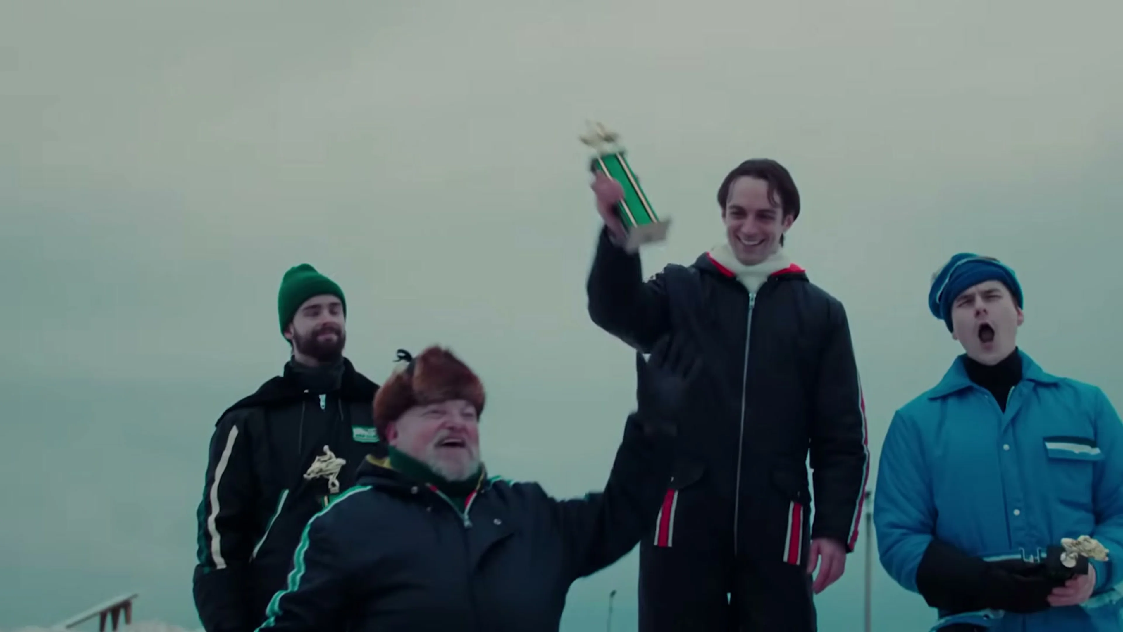 Gilles Villeneuve celebrates with a snowmobile racing team.
