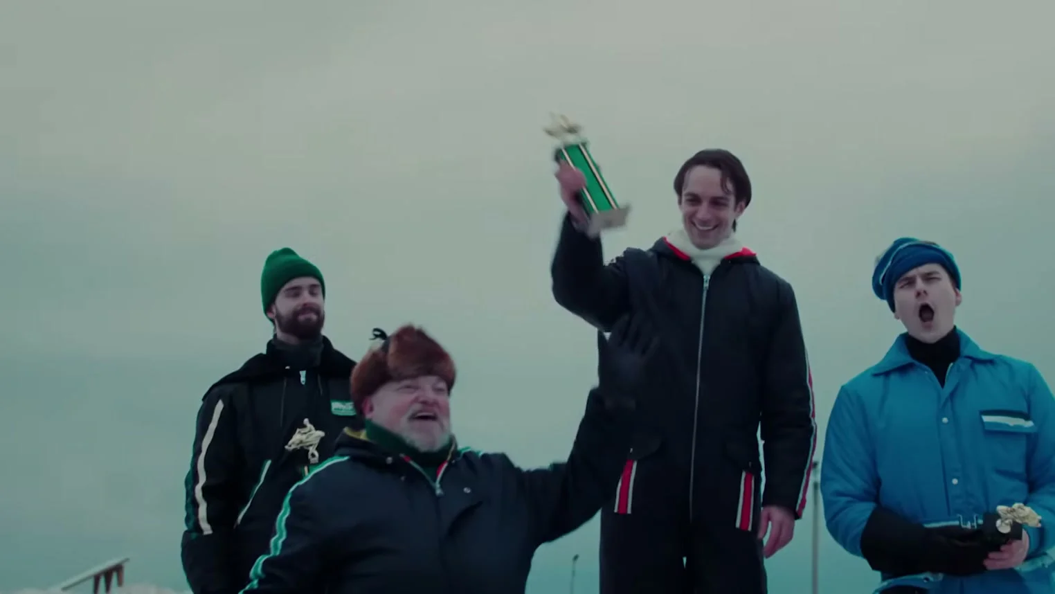 Gilles Villeneuve celebrates with a snowmobile racing team.
