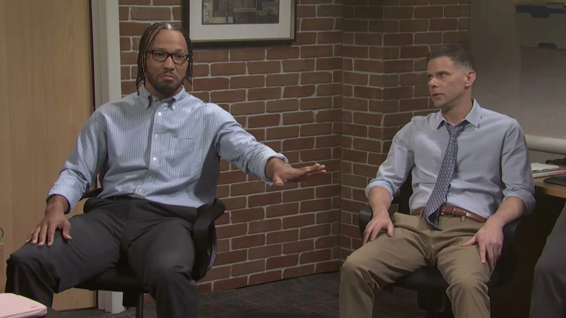 Jalen Brunson and Mikey Day sit in an office scene from the Saturday Night Live Office MVP sketch.