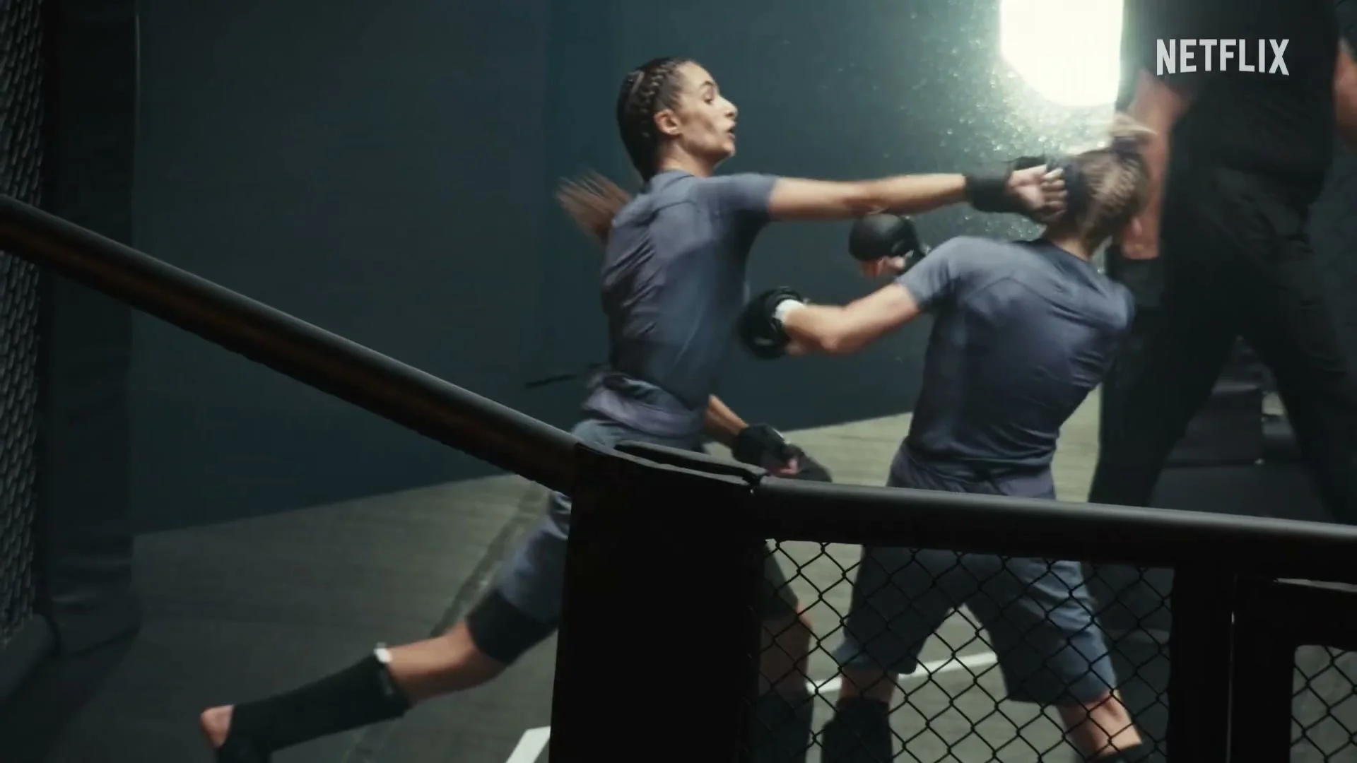 Two women compete inside the cage in the official trailer for L’Arène.