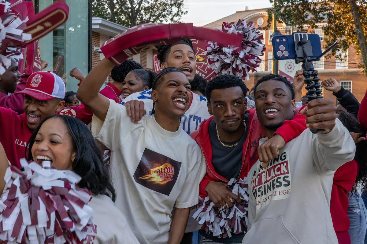 Students cheer together outside Hillman College in an official A Different World: The Legacy Continues still.