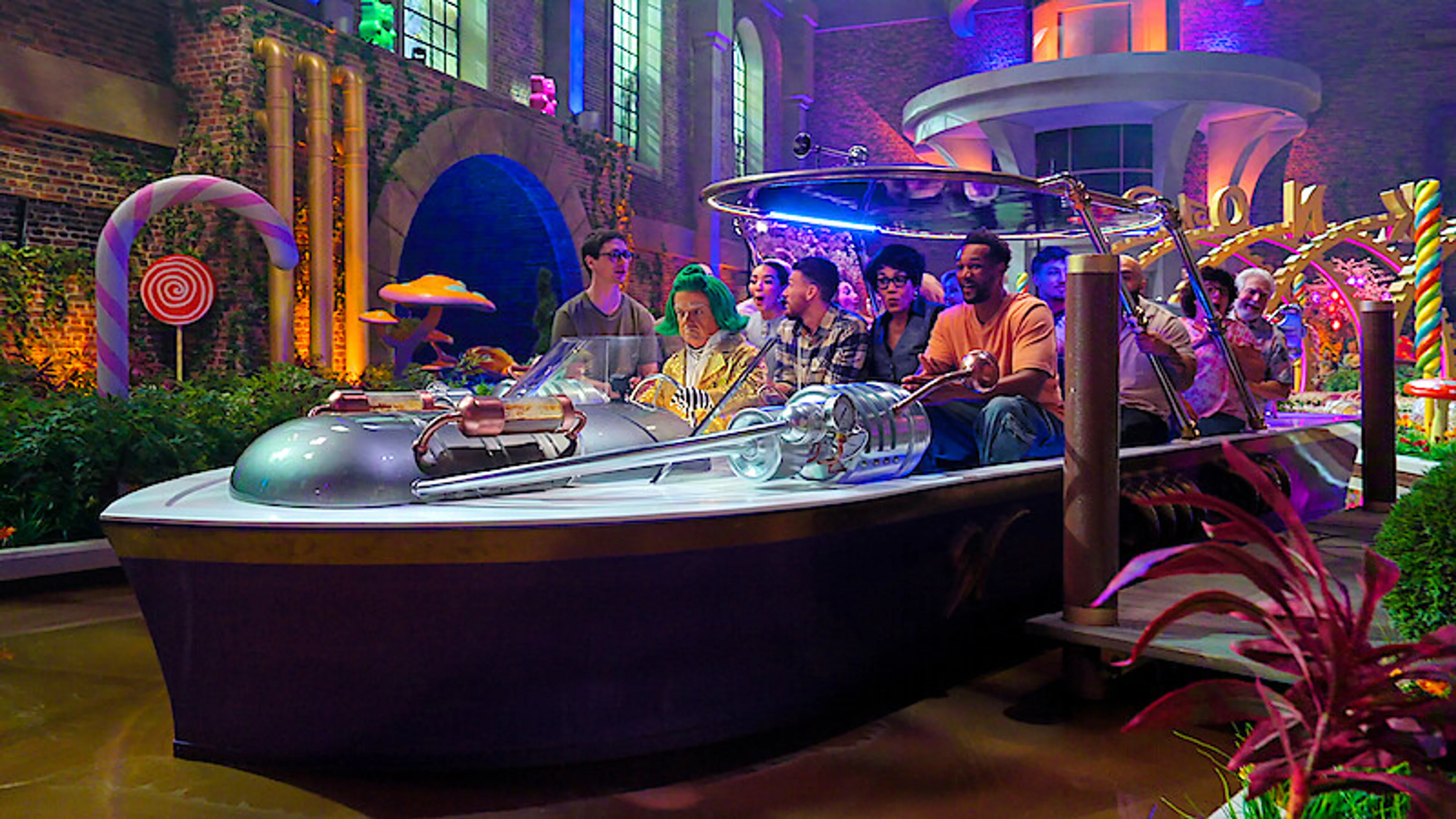 Contestants ride a boat through the new chocolate factory.