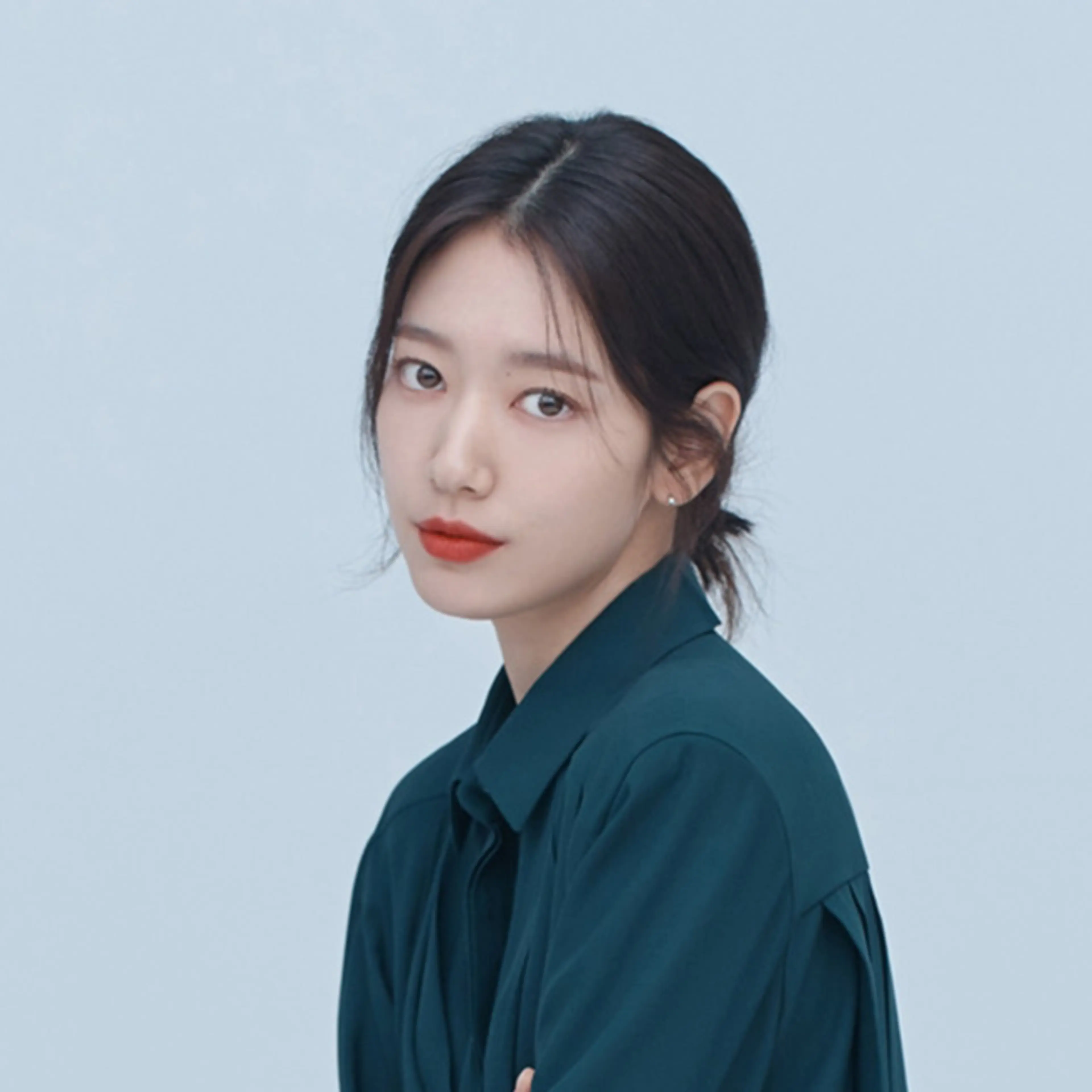 Park Shin-hye in a teal blouse against a light blue backdrop.