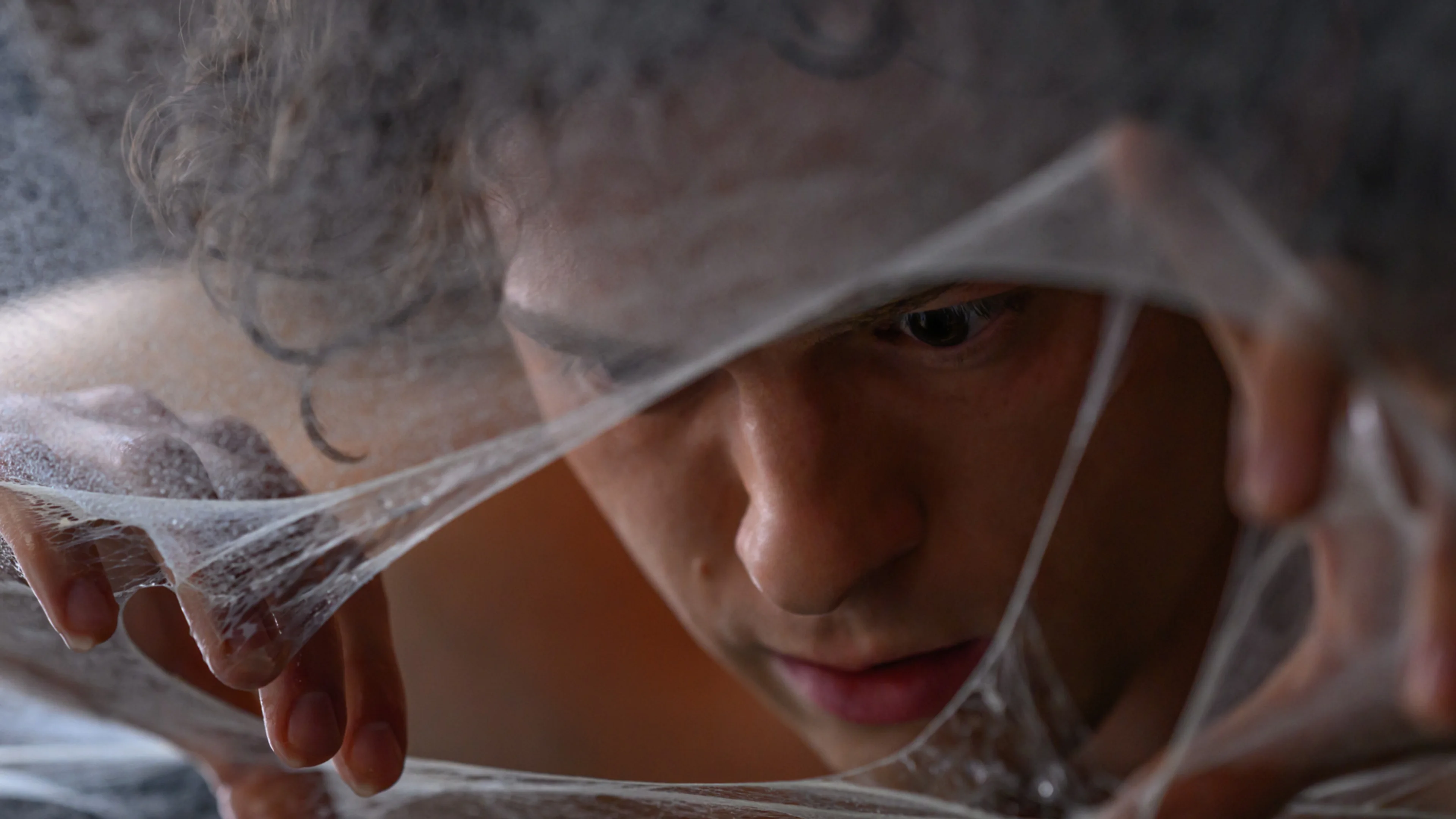 A child appears surrounded by webbing in Spider-Man: Brand New Day.