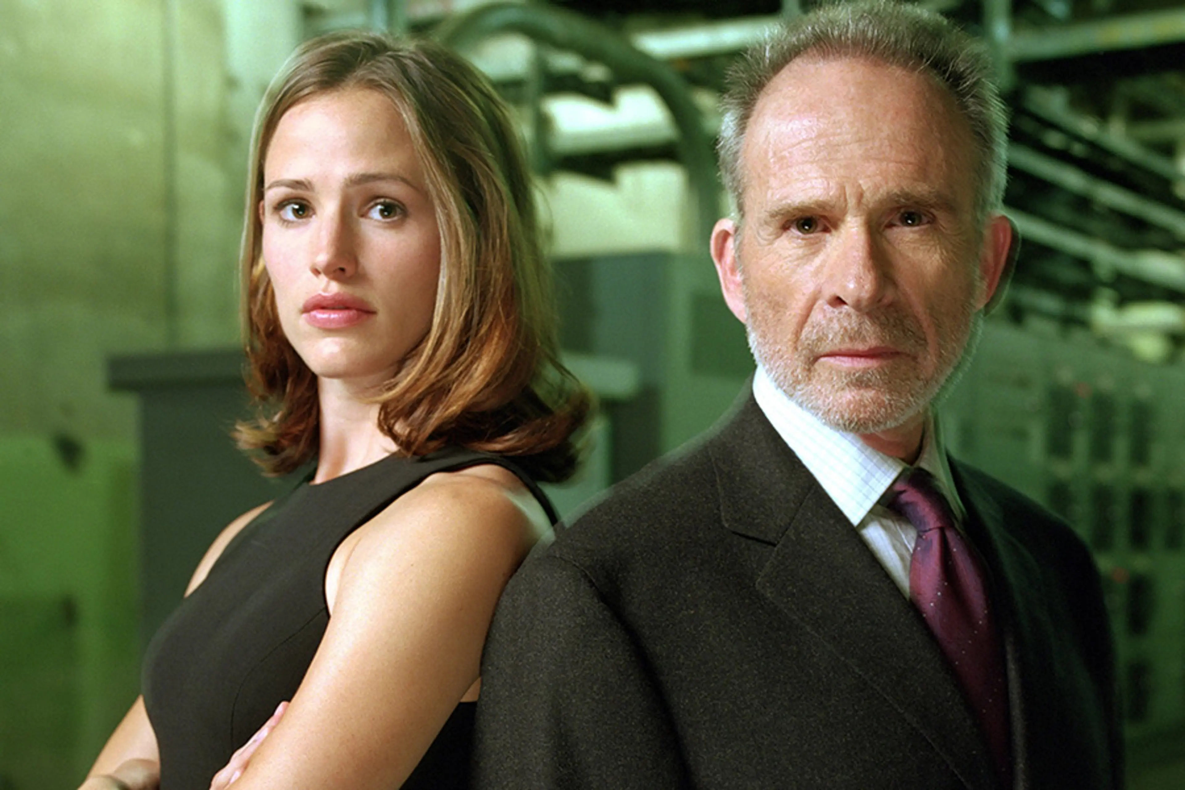 Jennifer Garner and Ron Rifkin stand back to back in Alias.