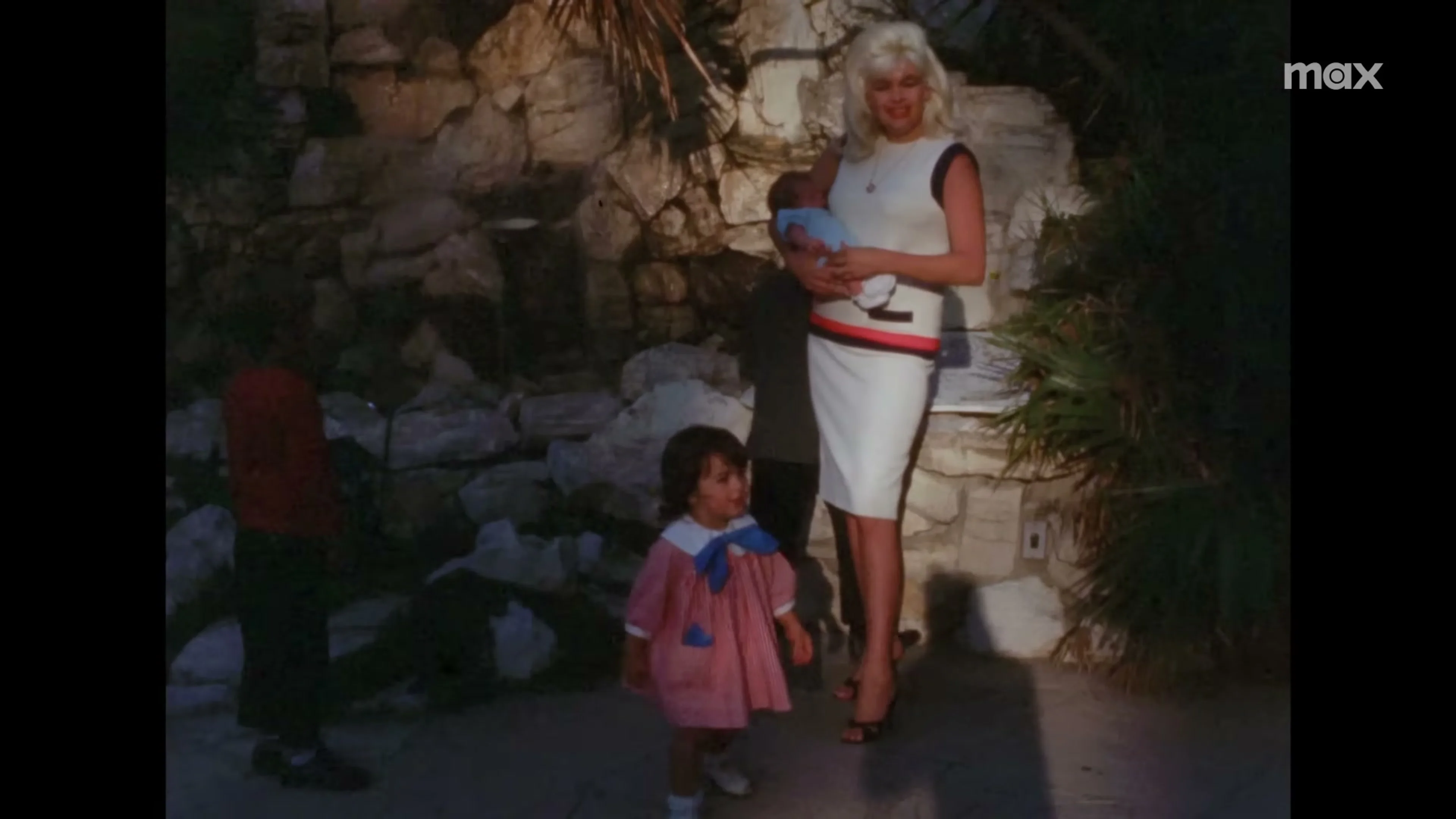 Jayne Mansfield holds a baby beside a young girl in archival footage from My Mom Jayne.