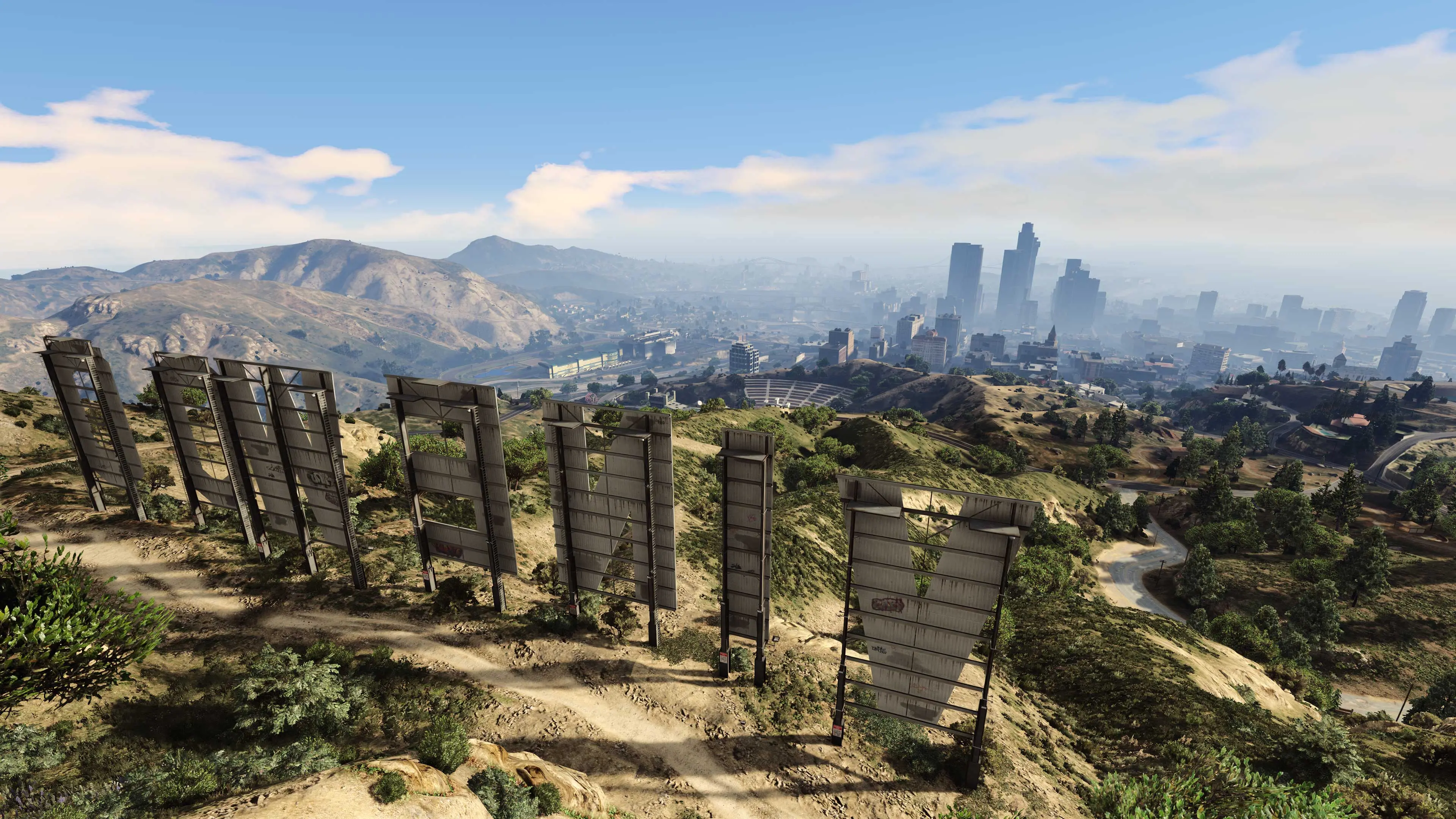 A wide view from behind the Vinewood sign across the GTA 5 map toward Los Santos.