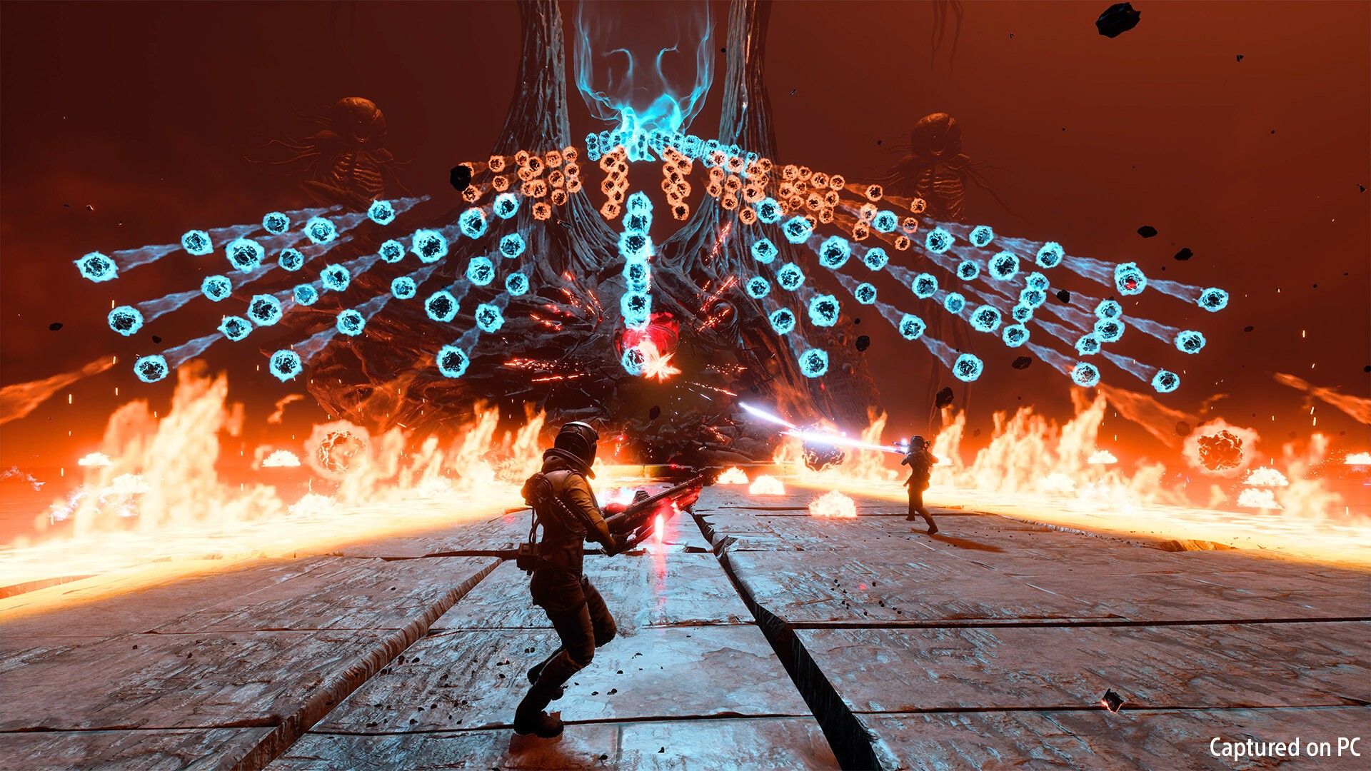 Selene fights amid a wide pattern of blue projectiles and fire.