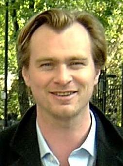 Christopher Nolan smiles in an outdoor portrait.