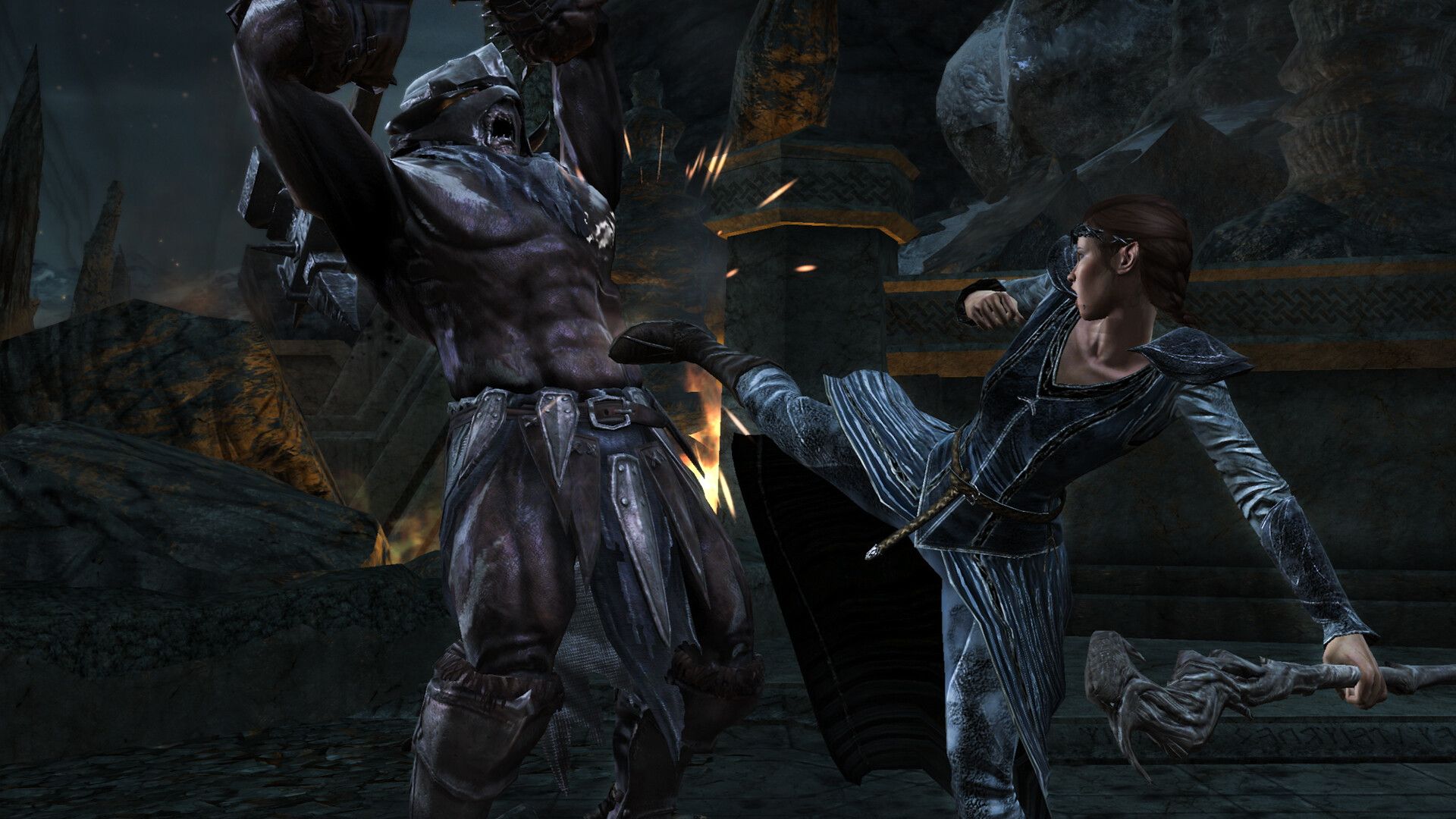 An elf kicks an armored enemy inside stone ruins in The Lord of the Rings: War in the North - Legacy Edition.