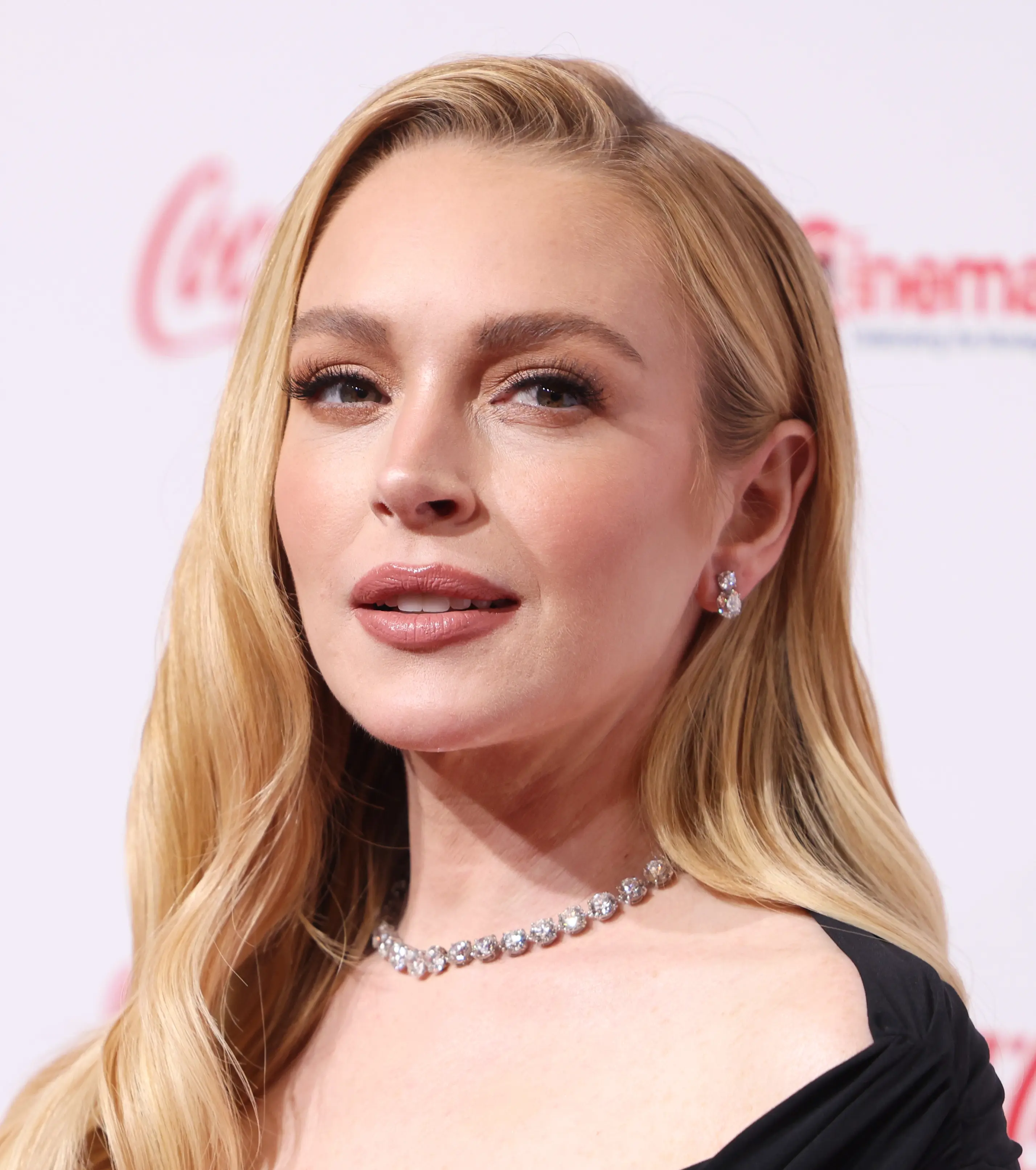 Lindsay Lohan at CinemaCon 2025 in a black dress.