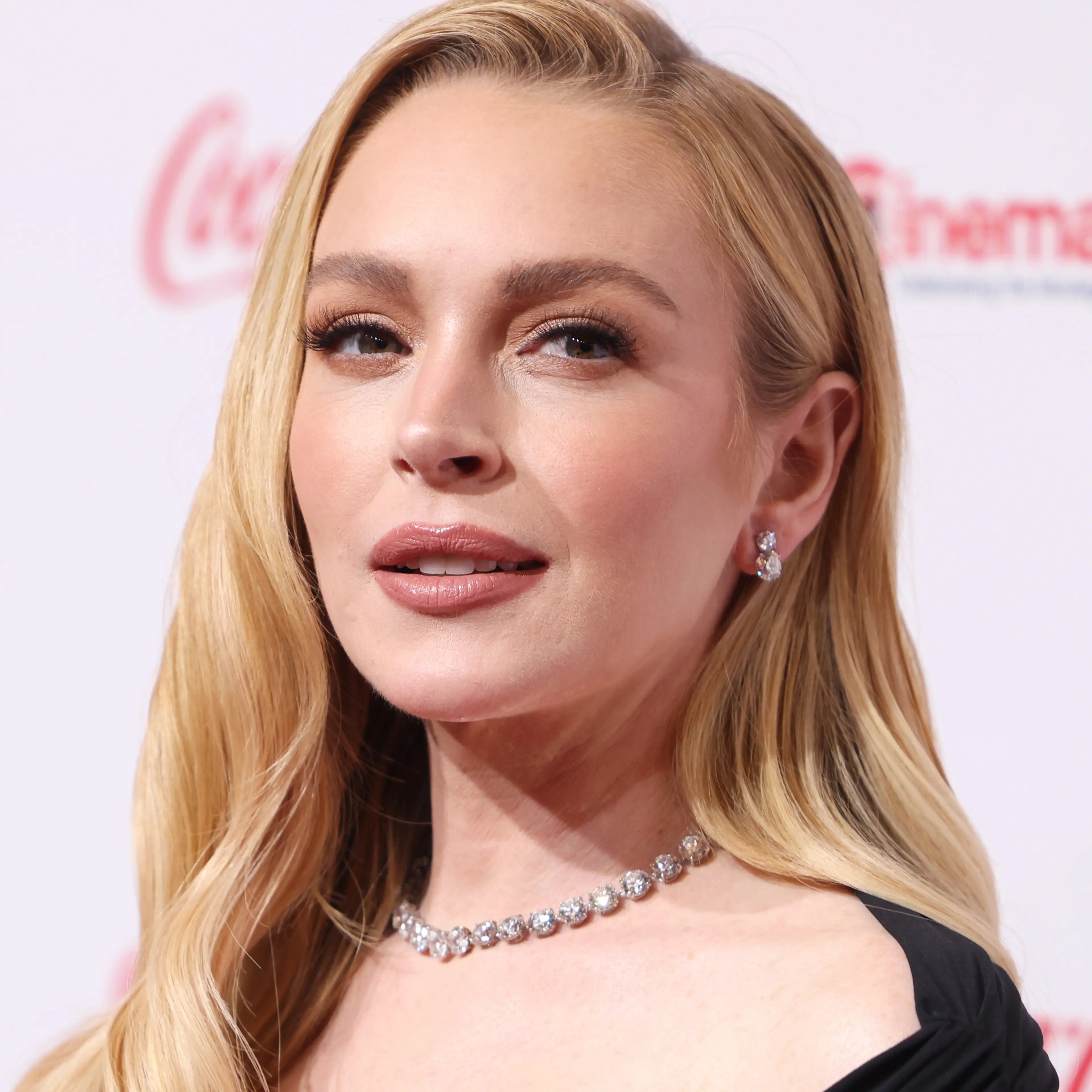 Lindsay Lohan at CinemaCon 2025 in a black dress.