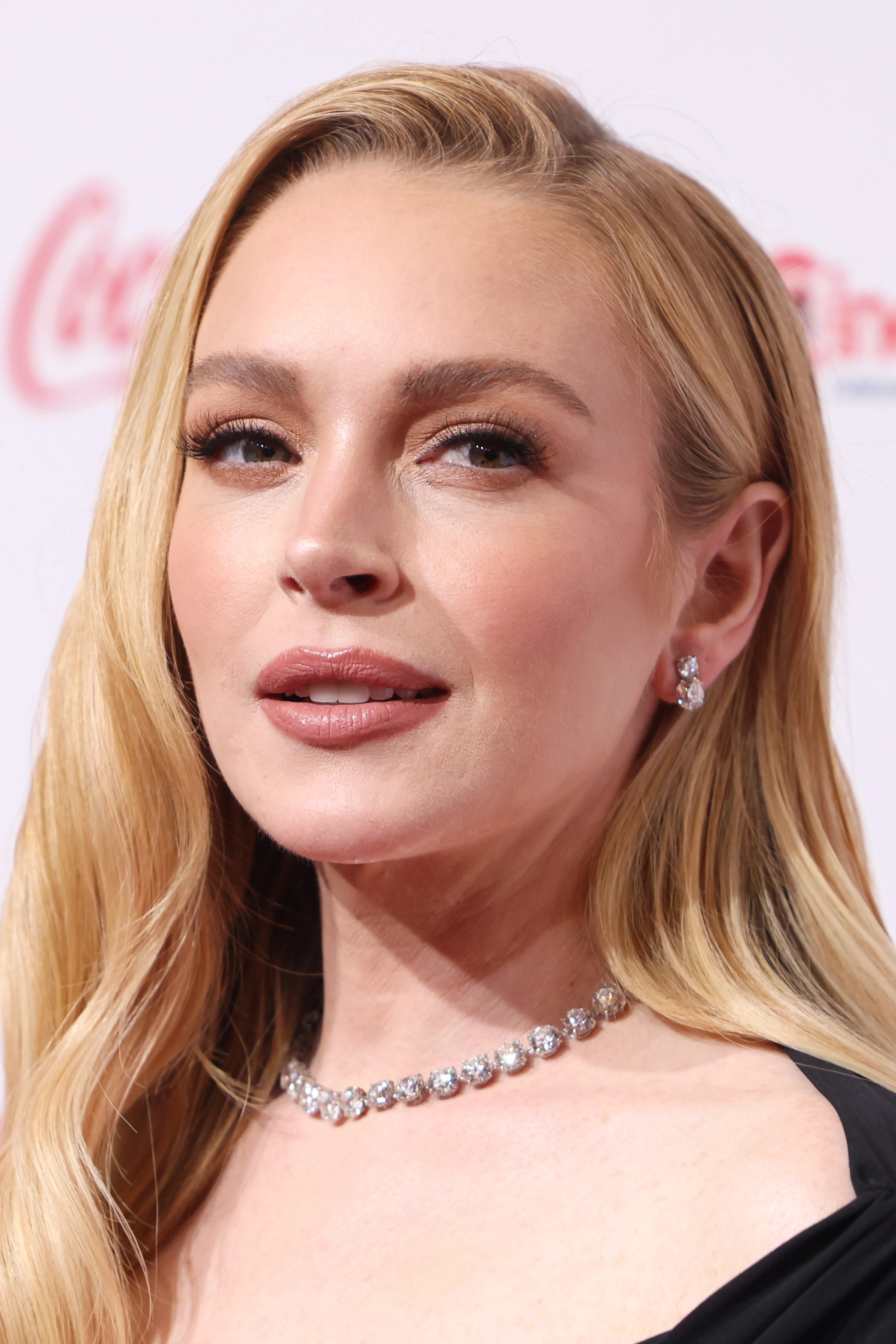 Lindsay Lohan at CinemaCon 2025 in a black dress.