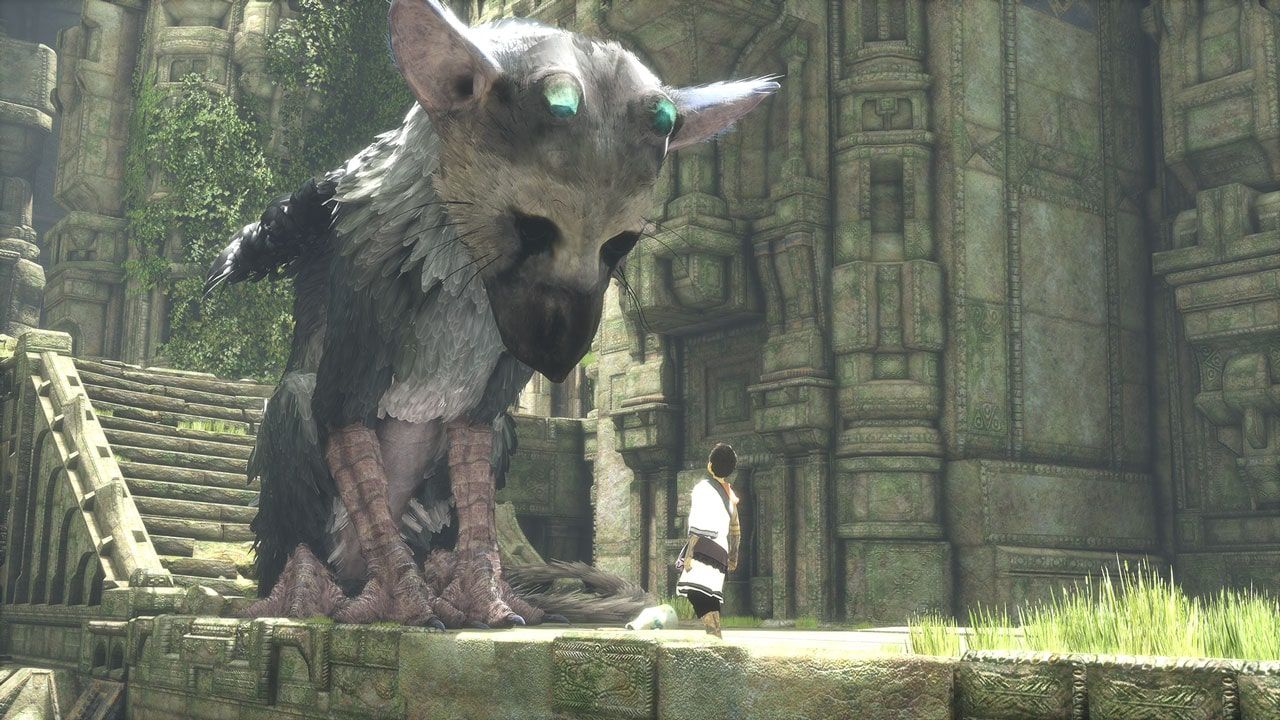 The boy in a white tunic standing before Trico in an old stone courtyard.