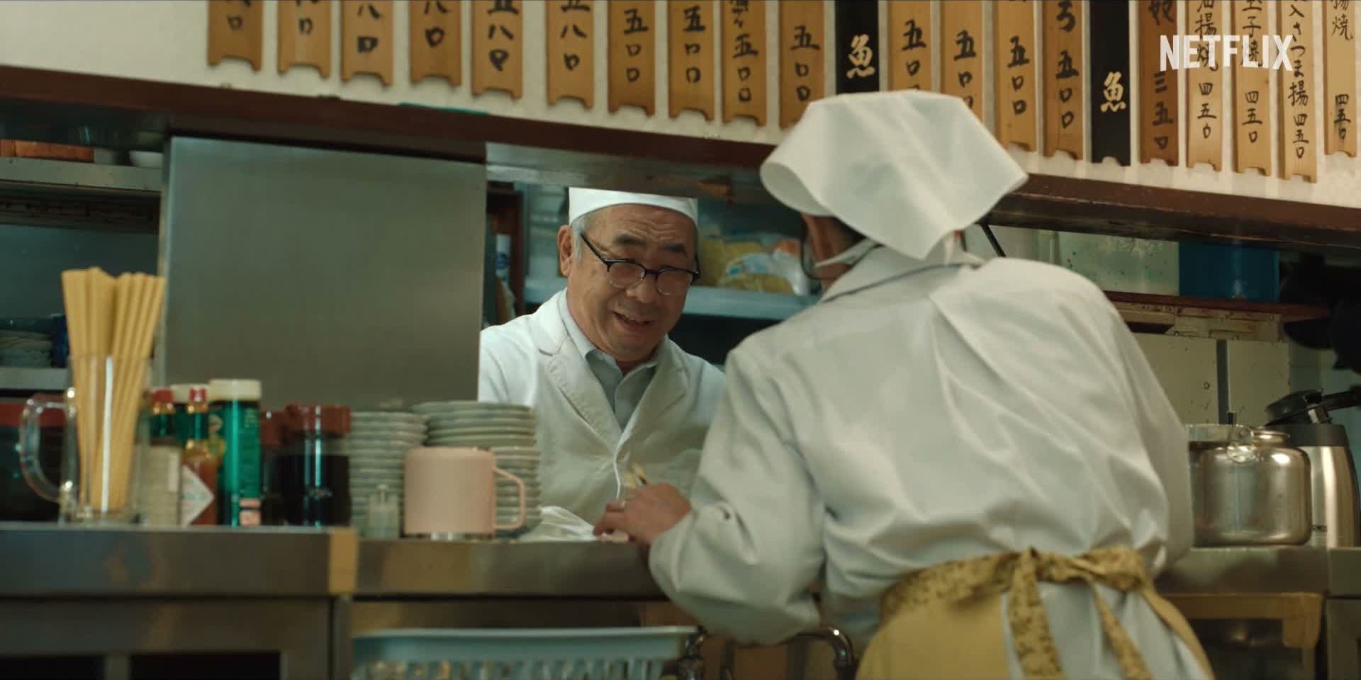 Two workers talk across the counter of a Japanese restaurant in the Quiztopia teaser.