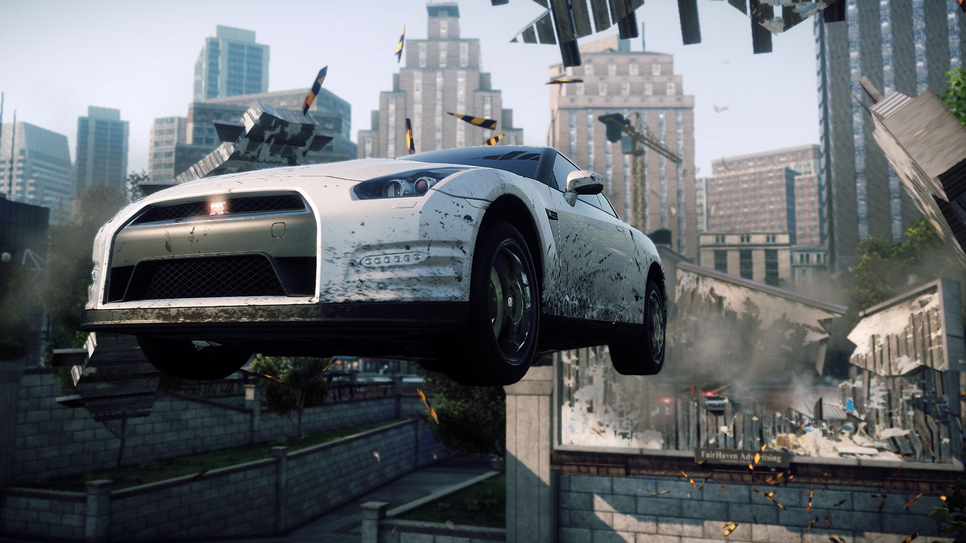 White sports car jumps through a billboard above city streets in Most Wanted.