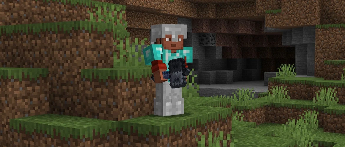 Steve holds a mace beside a cave entrance in Minecraft.