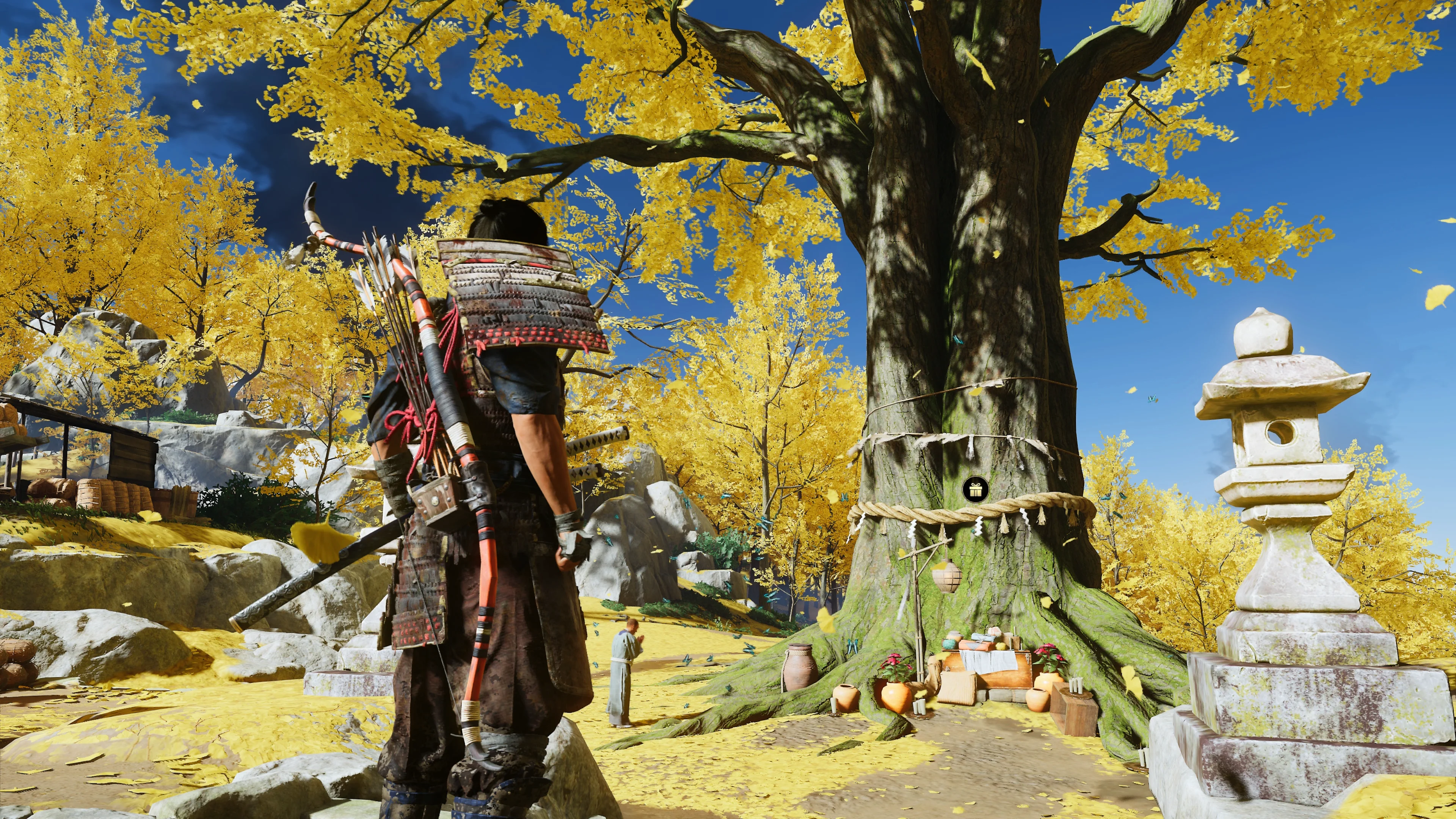 Jin stands before a large yellow-leaved tree with a small gift icon hanging on its trunk.