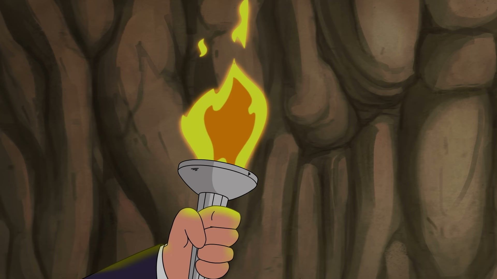 A torch lights the cave during the official teaser.