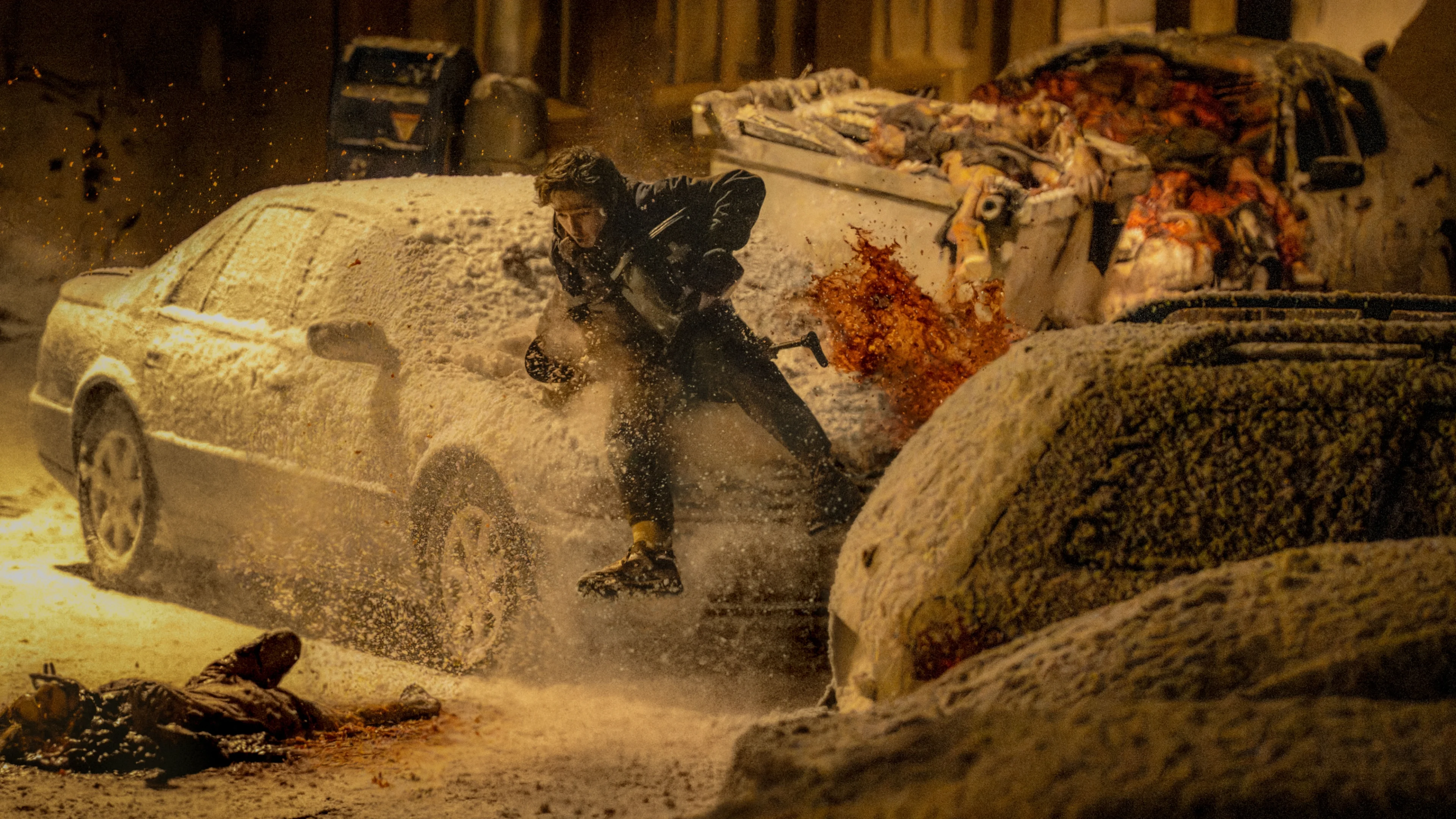 Bryan moves through snow between parked cars during a violent attack in Resident Evil.